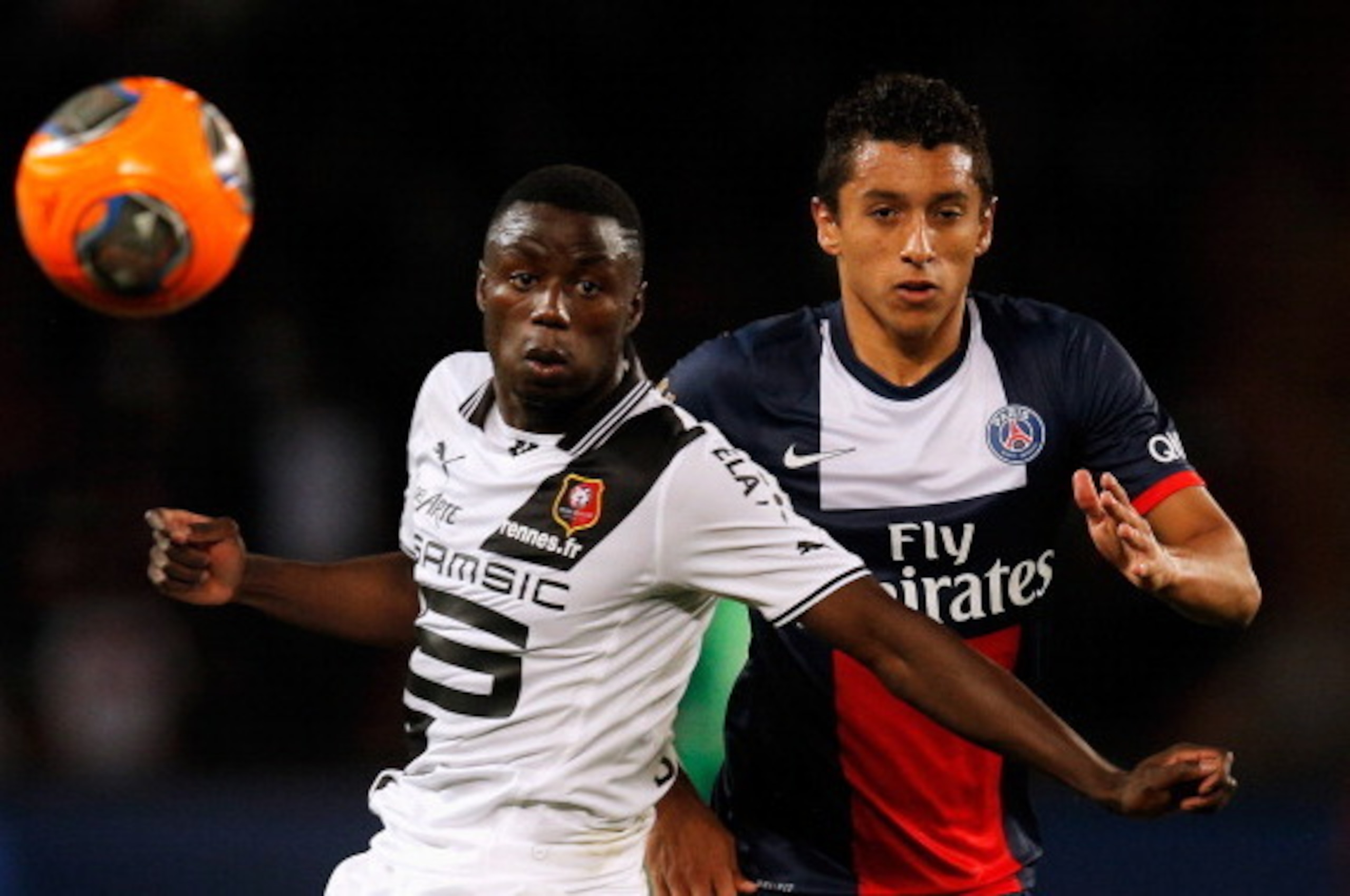 PARIS, FRANCE - MAY 07:  Marquinhos of PSG and Paul-Georges Ntep de Madiba of Rennais battle for the ball during the Ligue 1 match between Paris Saint-Germain FC and Stade Rennais FC at Parc des Princes on May 7, 2014 in Paris, France.  (Photo by Dean Mou