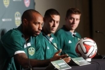 Aug 4, 2014; Portland, OR, USA; MLS All Star representative Thierry Henry (left) speaks while teammates Clint Dempsey (middle) and Matt Besler look on during a press conference in advance of the 2014 MLS All Star Game at The Nines Hotel. Mandatory Credit:
