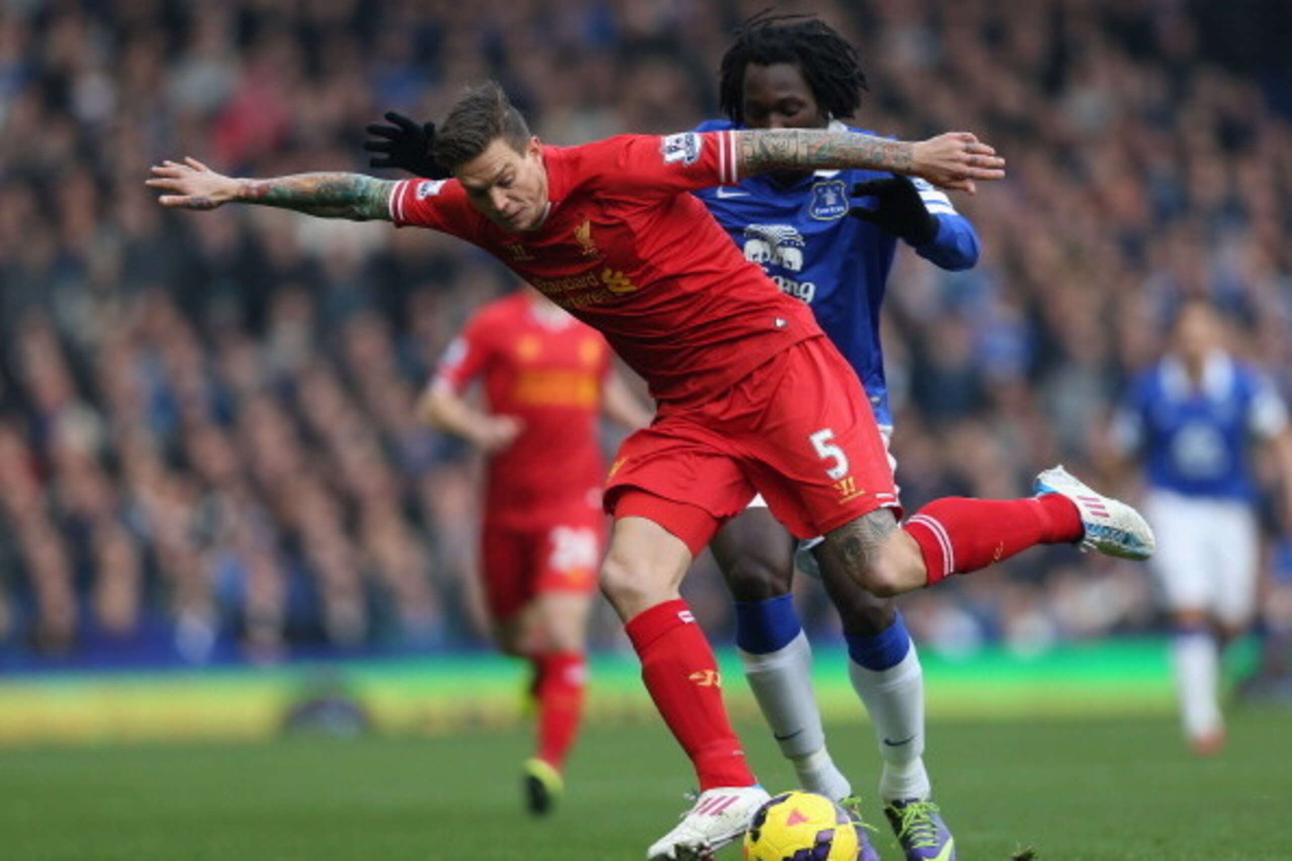 LIVERPOOL, ENGLAND - NOVEMBER 23: Daniel Agger of Liverpool competes with Romelu Lukaku of Everton during the Barclays Premier League match between Everton and Liverpool at Goodison Park on November 23, 2013 in Liverpool, England. (Photo by Clive Brunsk LIVERPOOL, ENGLAND - NOVEMBER 23: Daniel Agger of Liverpool competes with Romelu Lukaku of Everton during the Barclays Premier League match between Everton and Liverpool at Goodison Park on November 23, 2013 in Liverpool, England. (Photo by Clive Brunsk
