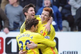 NEWCASTLE UPON TYNE, ENGLAND - FEBRUARY 01:  Jack Colback (R) of Sunderland is congratulated by teammates Marcos Alonso and Fabio Borini after scoring his team's third goal during the Barclays Premier League match between Newcastle United and Sunderland a