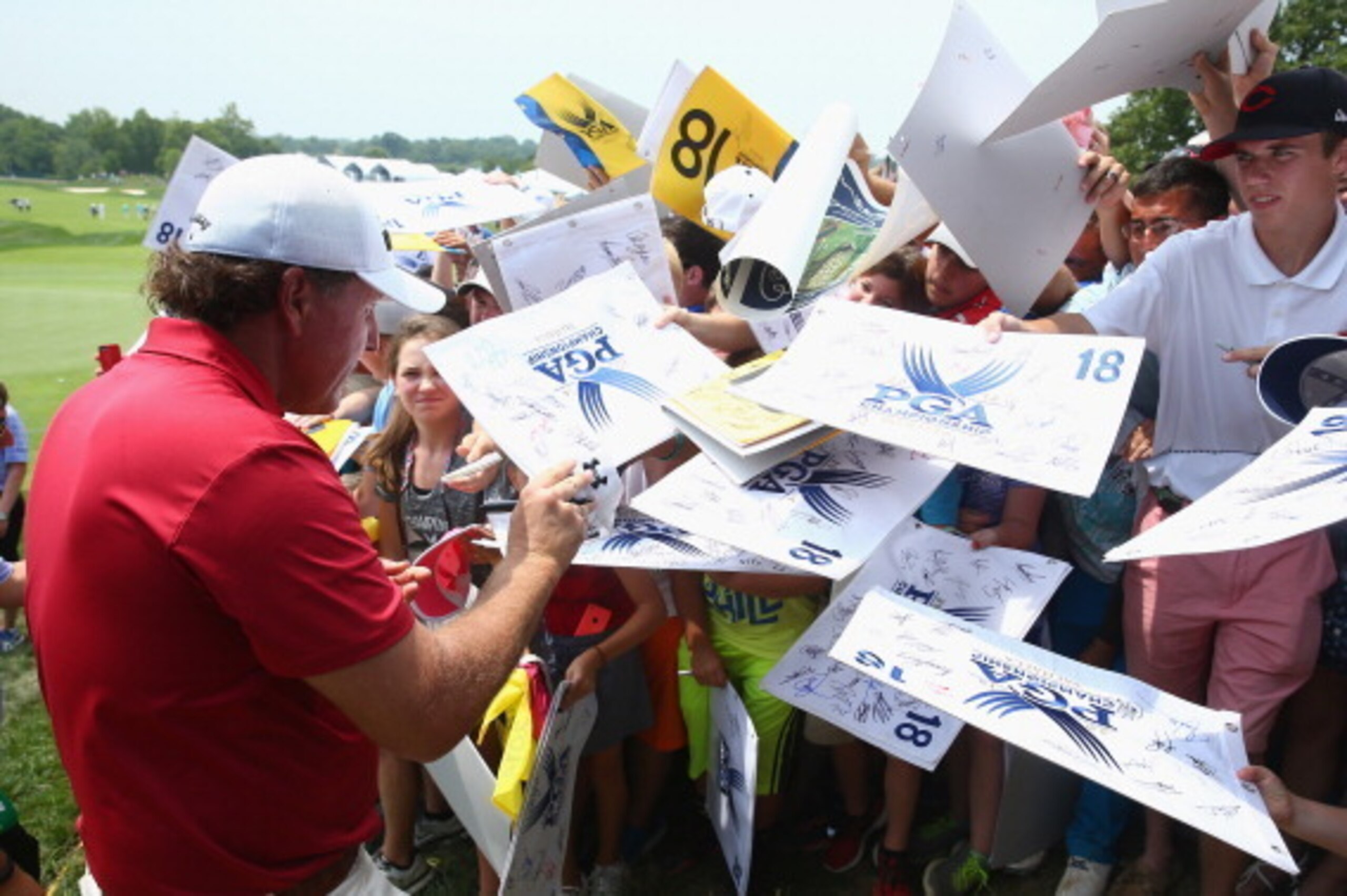 LOUISVILLE, KY - AUGUST 05:  Phil Mickelson of the United States signs his autograph for fans during a practice round prior to the start of the 96th PGA Championship at Valhalla Golf Club on August 5, 2014 in Louisville, Kentucky.  (Photo by Andy Lyons/Ge