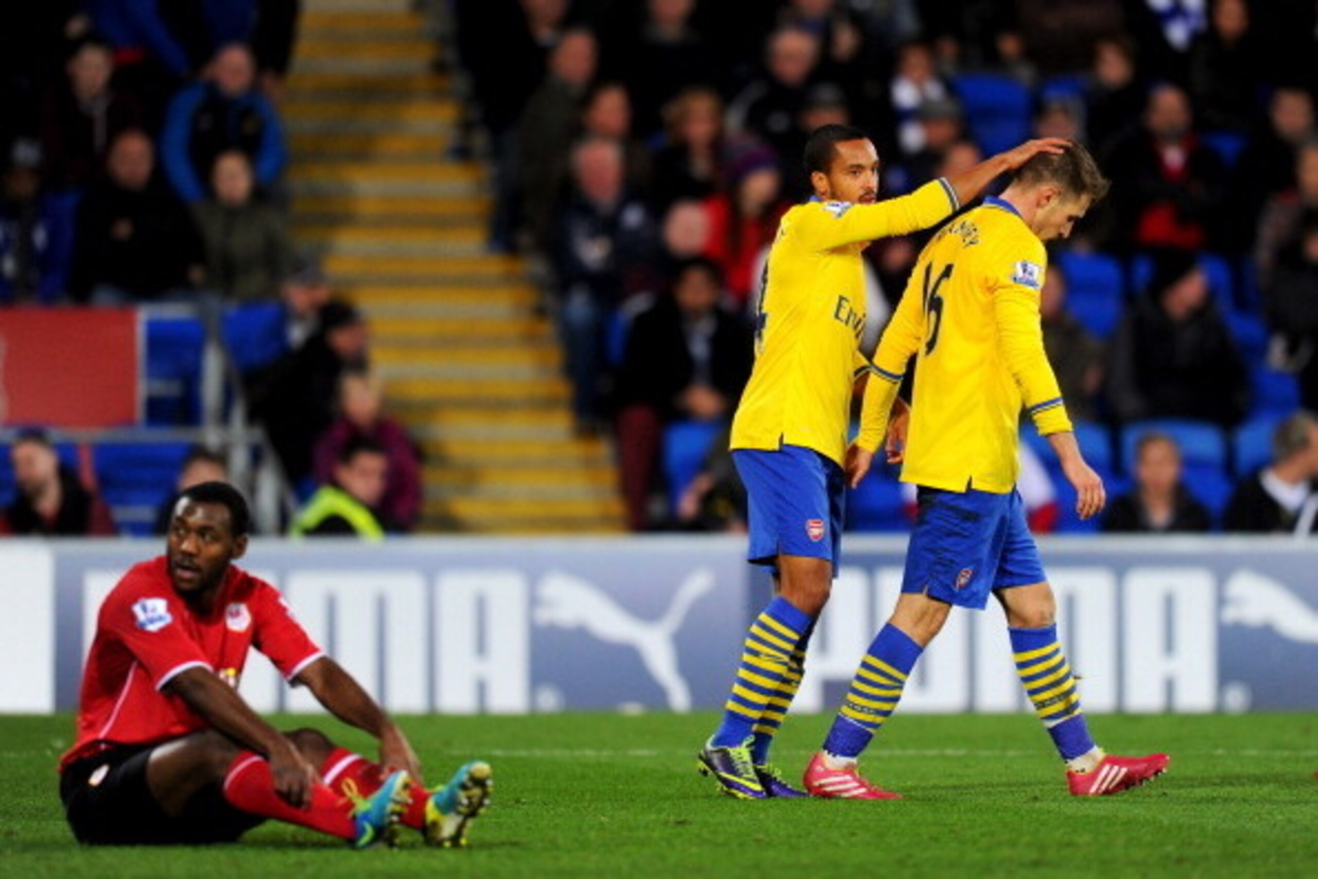 CARDIFF, WALES - NOVEMBER 30:  Aaron Ramsey of Arsenal (16) is congratulated by Theo Walcott as he scores their third goal during the Barclays Premier League match between Cardiff City and Arsenal at Cardiff City Stadium on November 30, 2013 in Cardiff, W