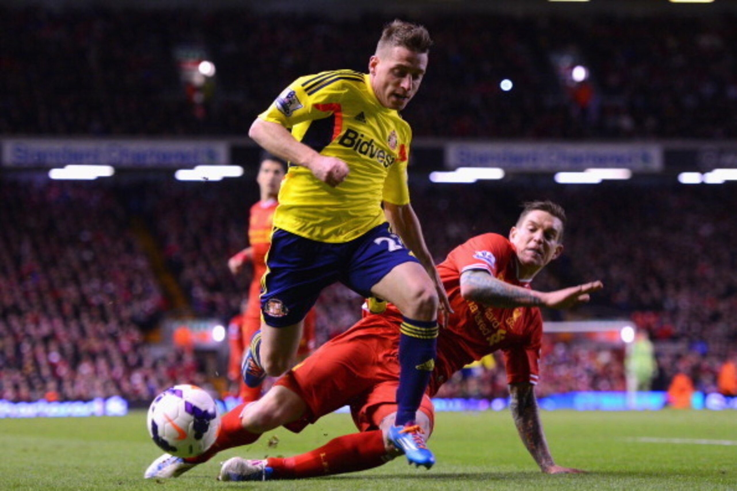 LIVERPOOL, ENGLAND - MARCH 26:  Daniel Agger of Liverpool challenges Emanuele Giaccherini of Sunderland during the Barclays Premier League match between Liverpool and Sunderland at Anfield on March 26, 2014 in Liverpool, England.  (Photo by Michael Regan/