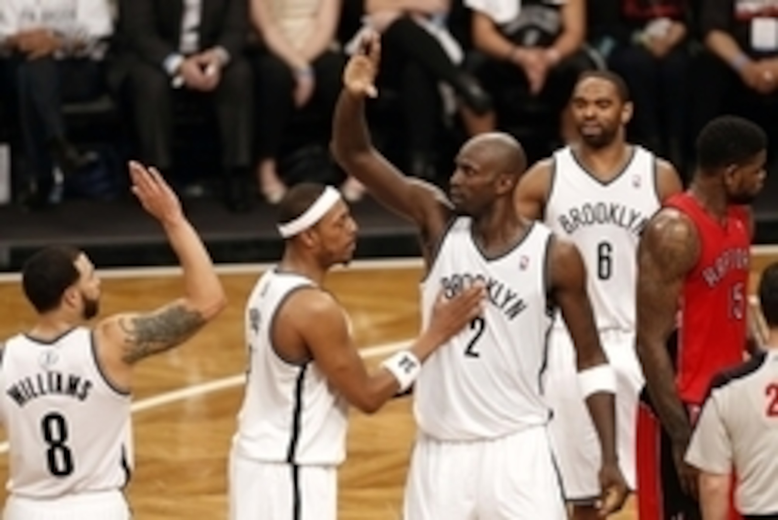 May 2, 2014; Brooklyn, NY, USA; Brooklyn Nets center Kevin Garnett (2) celebrates with forward Paul Pierce (34) and guard Deron Williams (8) against the Toronto Raptors during the first half in game six of the first round of the 2014 NBA Playoffs at Barcl