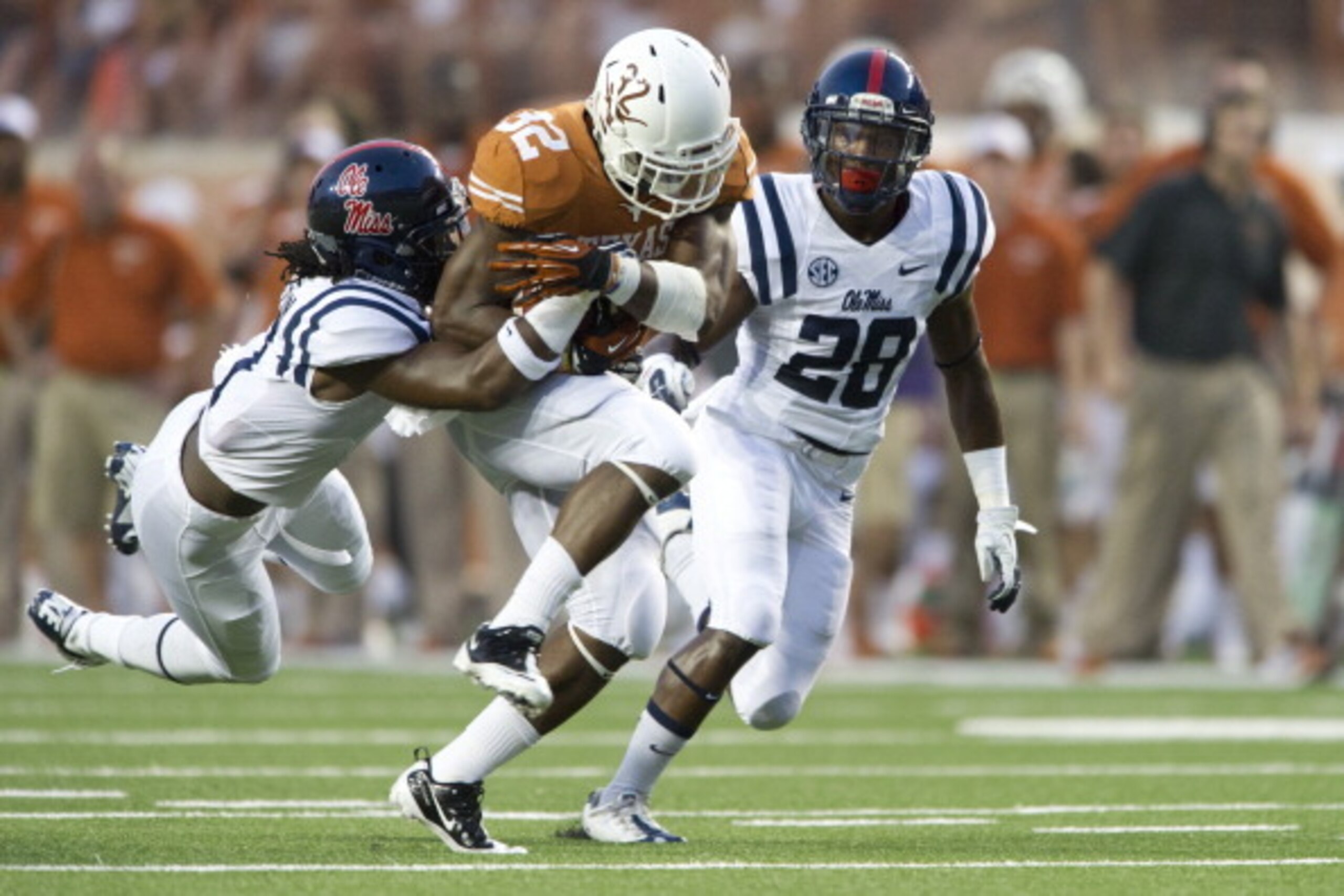 AUSTIN, TX - SEPTEMBER 14: Johnathan Gray #32 of the Texas Longhorns tries to break free against the Mississippi Rebels defense on September 14, 2013 at Darrell K Royal-Texas Memorial Stadium in Austin, Texas. (Photo by Cooper Neill/Getty Images) AUSTIN, TX - SEPTEMBER 14: Johnathan Gray #32 of the Texas Longhorns tries to break free against the Mississippi Rebels defense on September 14, 2013 at Darrell K Royal-Texas Memorial Stadium in Austin, Texas. (Photo by Cooper Neill/Getty Images)