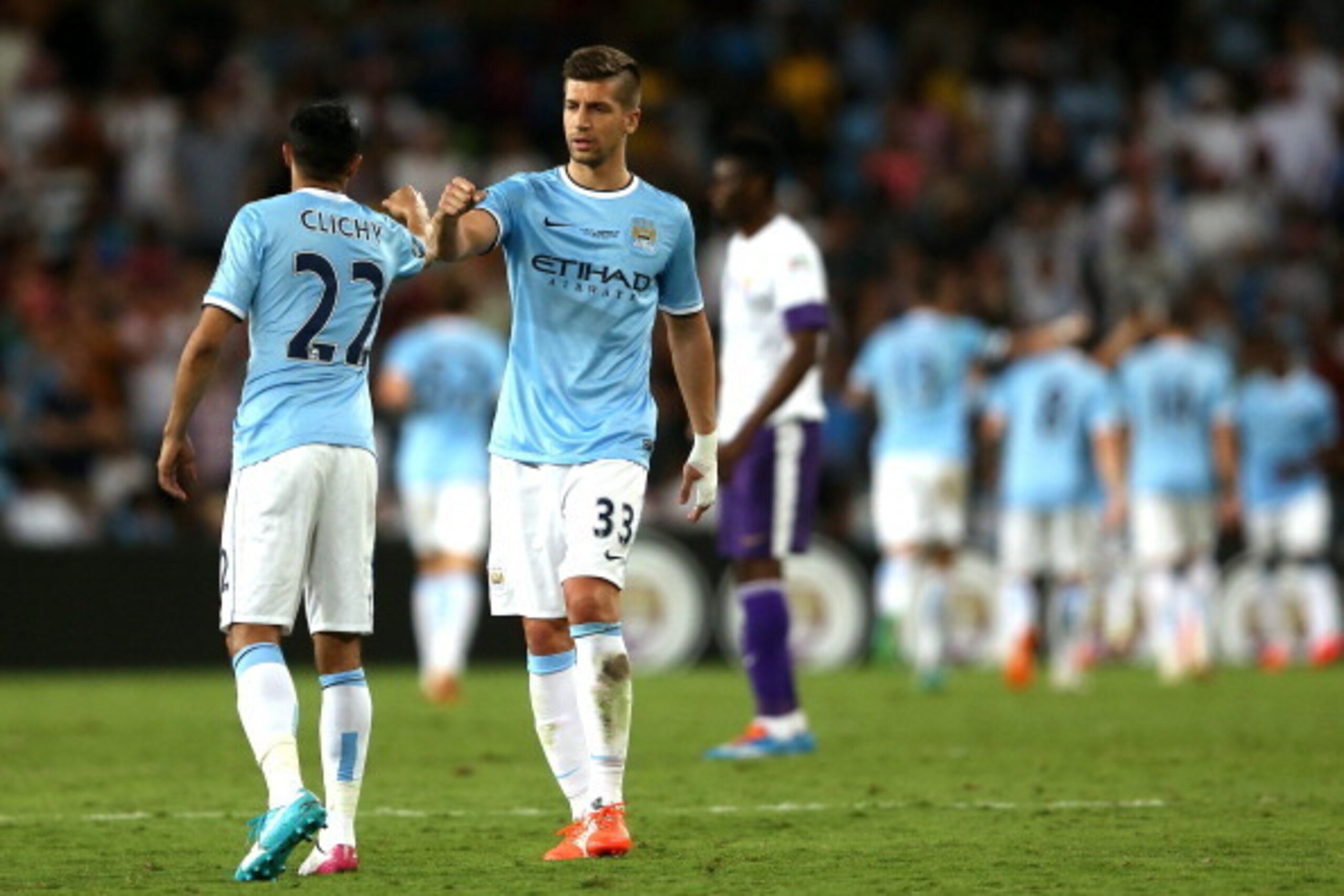 AL AIN, UNITED ARAB EMIRATES - MAY 15:  Matija Nastasic and Gael Clichy of Manchester City celebrate the goal of team mate Maroc Lopes during the friendly match between Al Ain and Manchester City at Hazza bin Zayed Stadium on May 15, 2014 in Al Ain, Unite