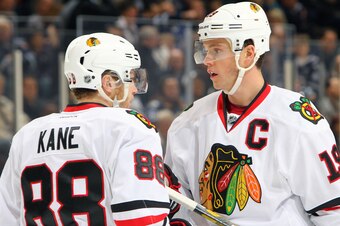 WINNIPEG, MB - NOVEMBER 21: Patrick Kane #88 and Jonathan Toews #19 of the Chicago Blackhawks discuss strategy during first period action against the Winnipeg Jets at the MTS Centre on November 21, 2013 in Winnipeg, Manitoba, Canada. (Photo by Jonathan Ko