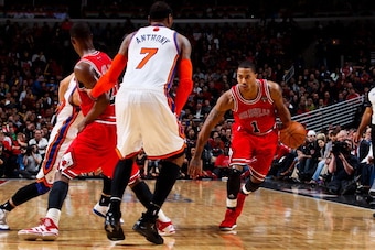 CHICAGO, IL - MARCH 12: Derrick Rose #1 of the Chicago Bulls drives on a screen by teammate Jimmy Butler #21 against Carmelo Anthony #7 and Jeremy Lin #17 of the New York Knicks on March 12, 2012 at the United Center in Chicago, Illinois. NOTE TO USER:  U