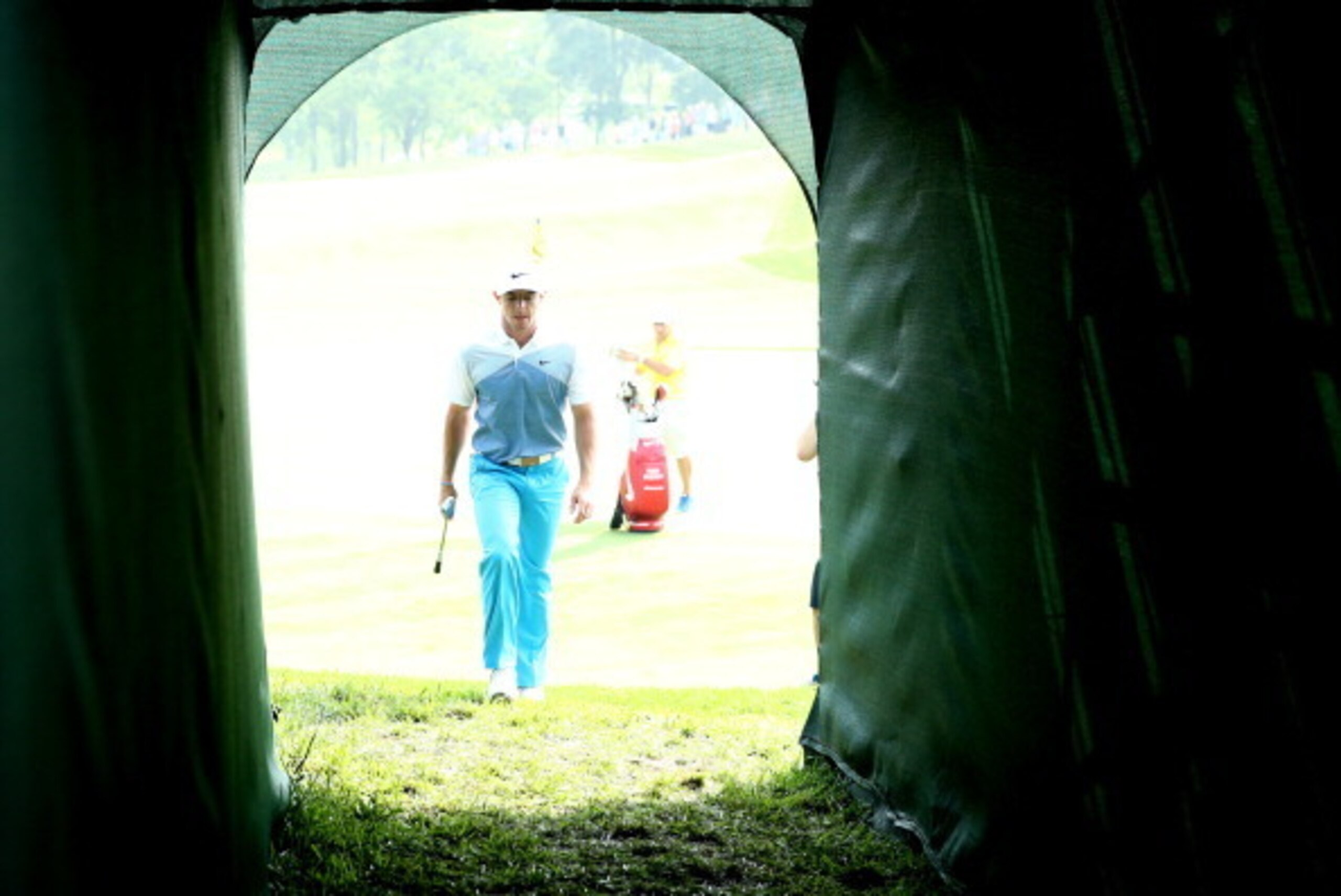 LOUISVILLE, KY - AUGUST 06:  Rory McIlroy of Northern Ireland walks through the tunnel to the 18th hole during a practice round prior to the start of the 96th PGA Championship at Valhalla Golf Club on August 6, 2014 in Louisville, Kentucky.  (Photo by War