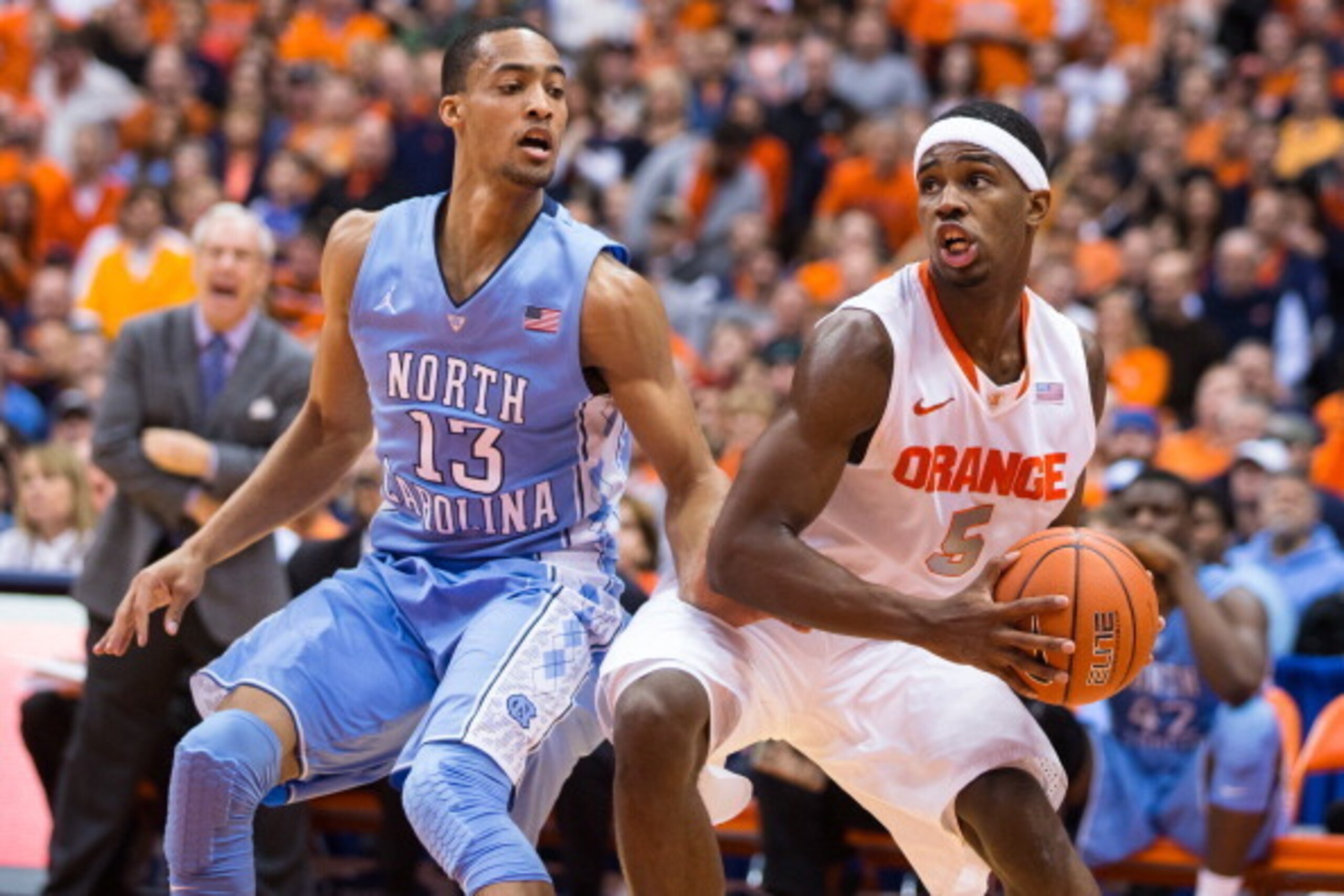 SYRACUSE, NY - JANUARY 11:  J.P. Tokoto #13 of the North Carolina Tar Heels defends C.J. Fair #5 of the Syracuse Orange as he drives along the baseline in the first half on January 11, 2014 at The Carrier Dome in Syracuse, New York. (Photo by Brett Carlse