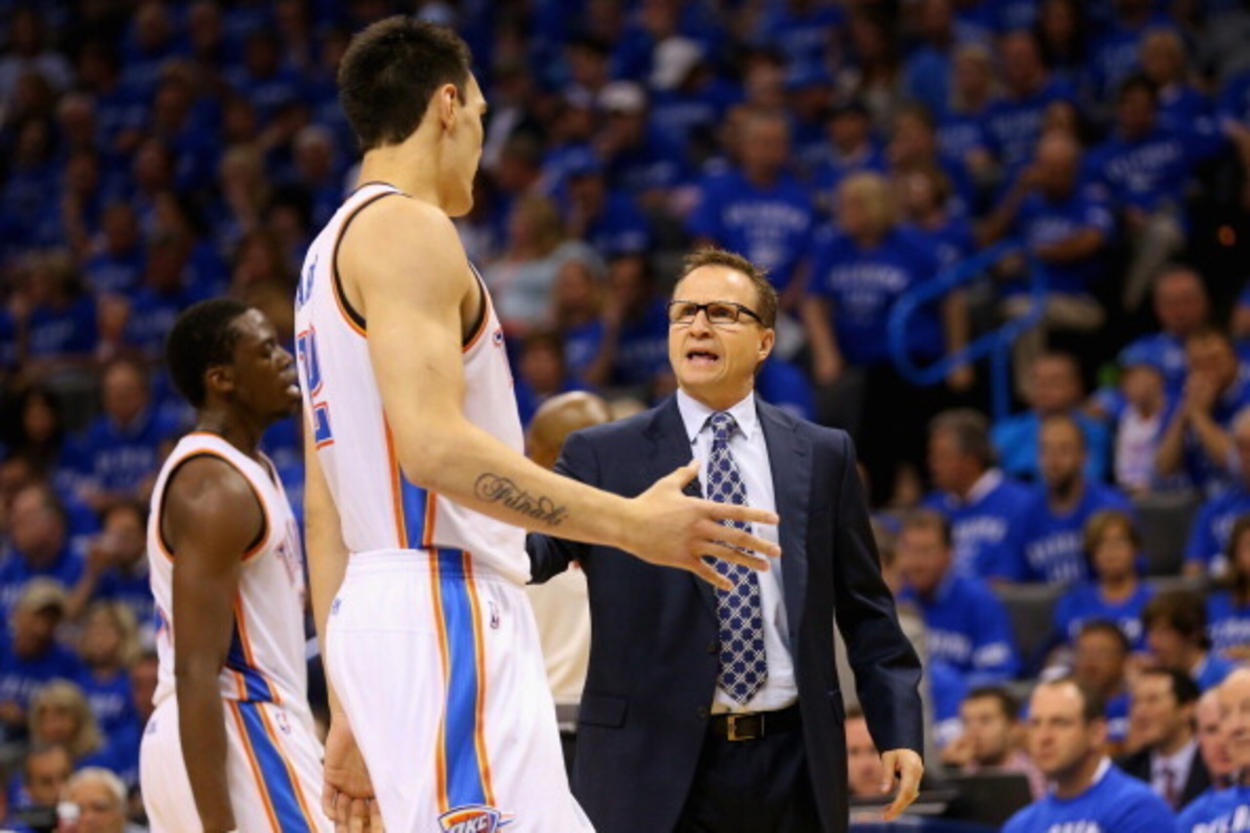 OKLAHOMA CITY, OK - MAY 25: Head coach Scott Brooks of the Oklahoma City Thunder talks to Steven Adams #12 in the third quarter against the San Antonio Spurs during Game Three of the Western Conference Finals of the 2014 NBA Playoffs at Chesapeake Energy 
