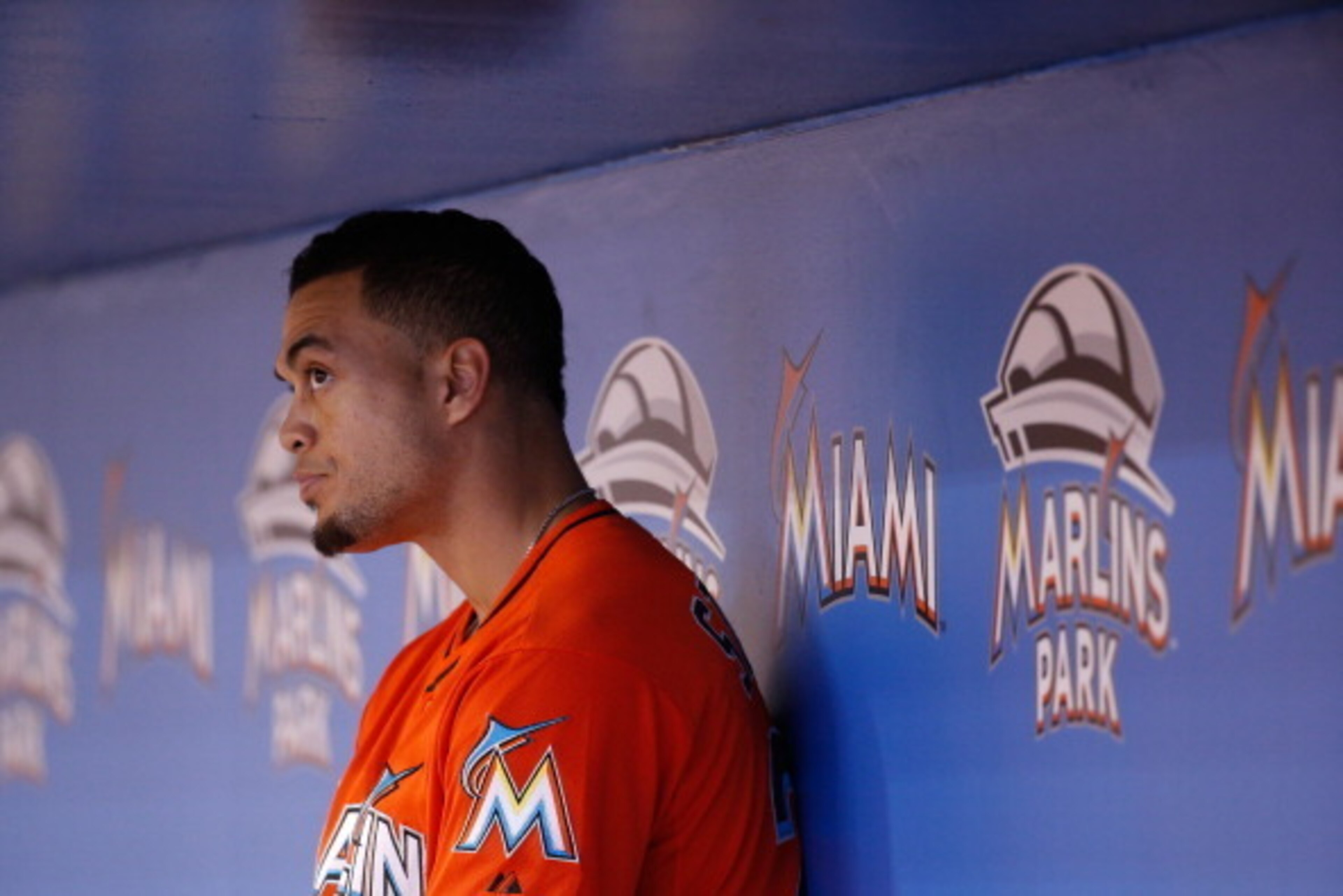 MIAMI, FL - AUGUST 03: Giancarlo Stanton #27 of the Miami Marlins looks on from the dugout during the ninth inning of the game against the Cincinnati Reds at Marlins Park on August 03, 2014 in Miami, Florida.  (Photo by Rob Foldy/Getty Images)