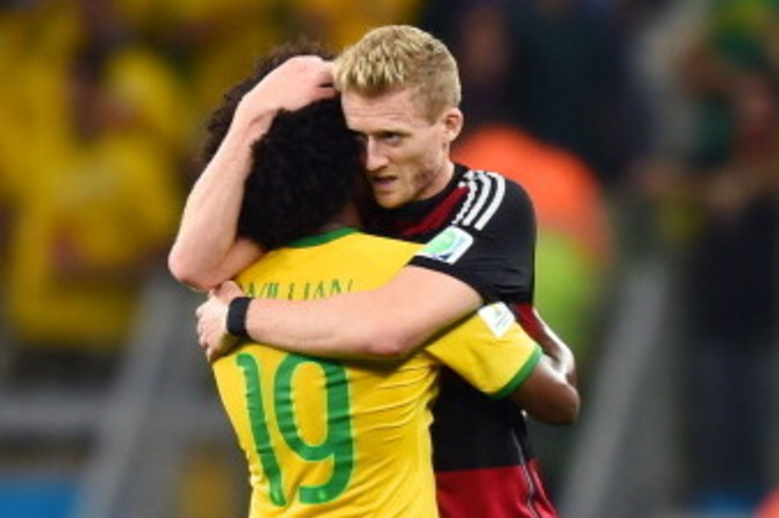 BELO HORIZONTE, BRAZIL - JULY 08: Andre Schuerrle (R) of Germany comforts Willian of Brazil after the 2014 FIFA World Cup Brazil Semi Final match between Brazil and Germany at Estadio Mineirao on July 8, 2014 in Belo Horizonte, Brazil.  (Photo by Buda Men