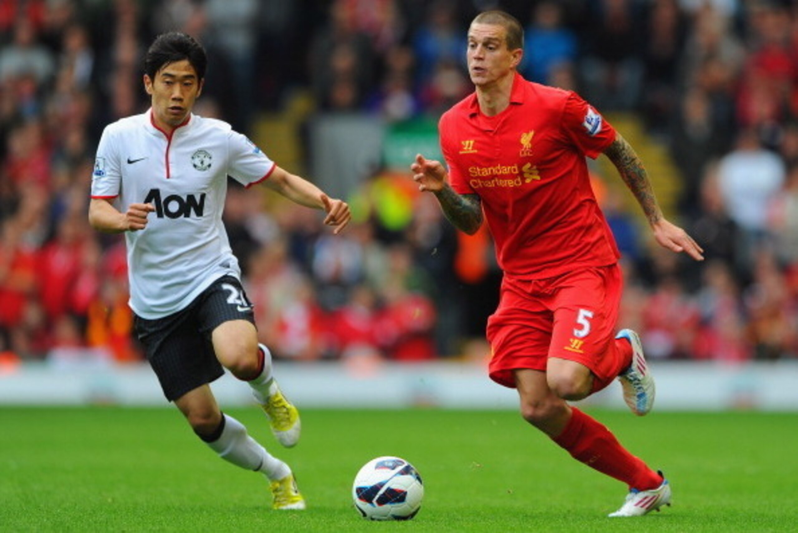 LIVERPOOL, ENGLAND - SEPTEMBER 23: Daniel Agger of Liverpool in action with Shinji Kagawa of Manchester United during the Barclays Premier League match between Liverpool and Manchester United at Anfield on September 23, 2012 in Liverpool, England.  (Photo