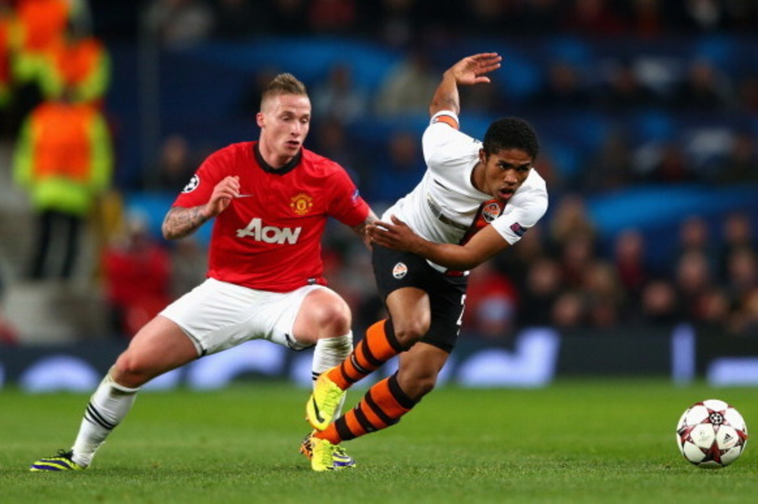 MANCHESTER, ENGLAND - DECEMBER 10:  Alexander Buttner of Manchester United competes with Douglas Costa of Shakhtar Donetsk during the UEFA Champions League Group A match between Manchester United and Shakhtar Donetsk at Old Trafford on December 10, 2013 i