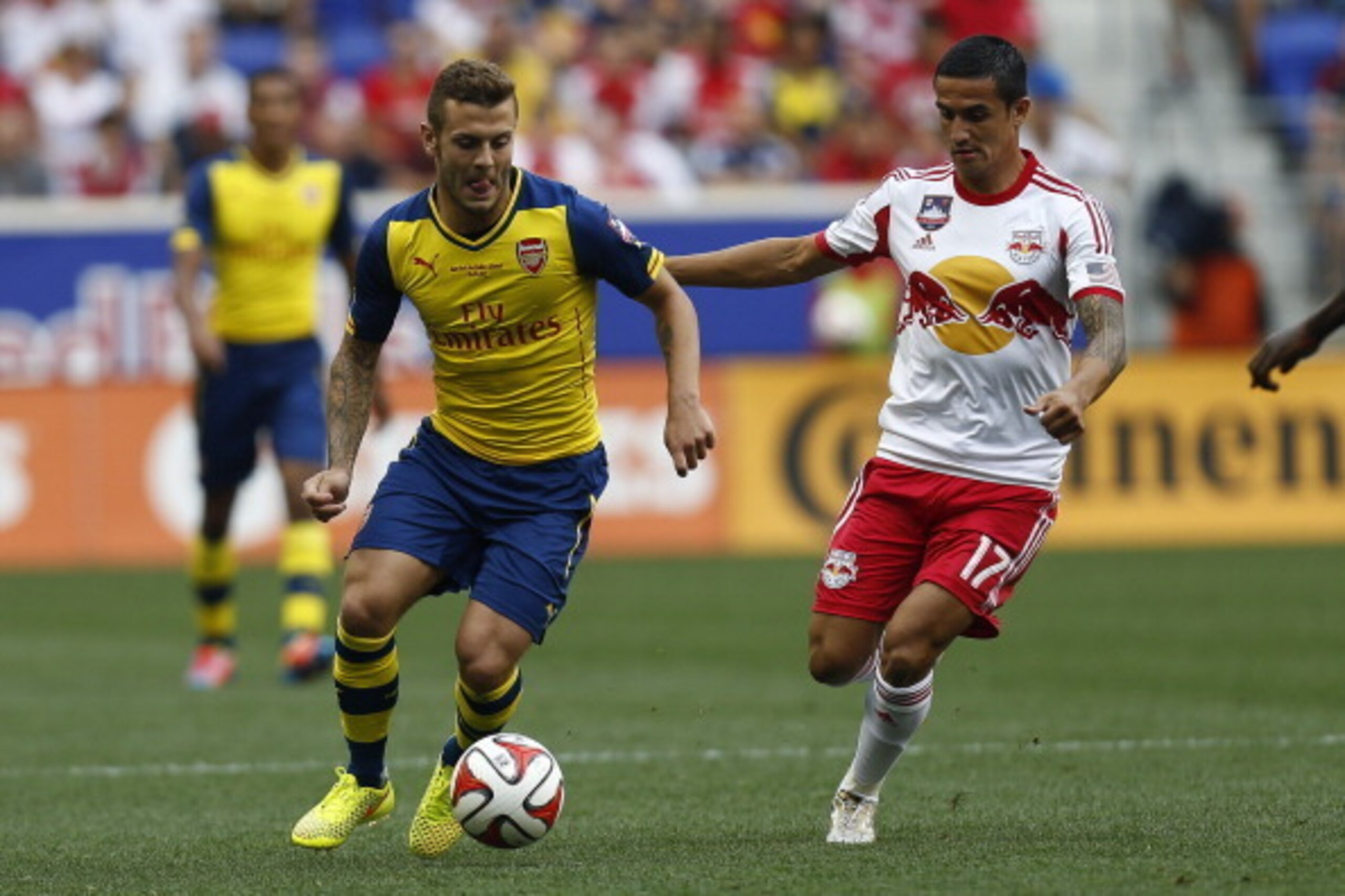 HARRISON, NJ - JULY 26:  Jack Wilshere #10 of Arsenal fights for the ball with Tim Cahill #17 of New York Red Bulls during their friendly match at Red Bull Arena on July 26, 2014 in Harrison, NJ. (Photo by Jeff Zelevansky/Getty Images)