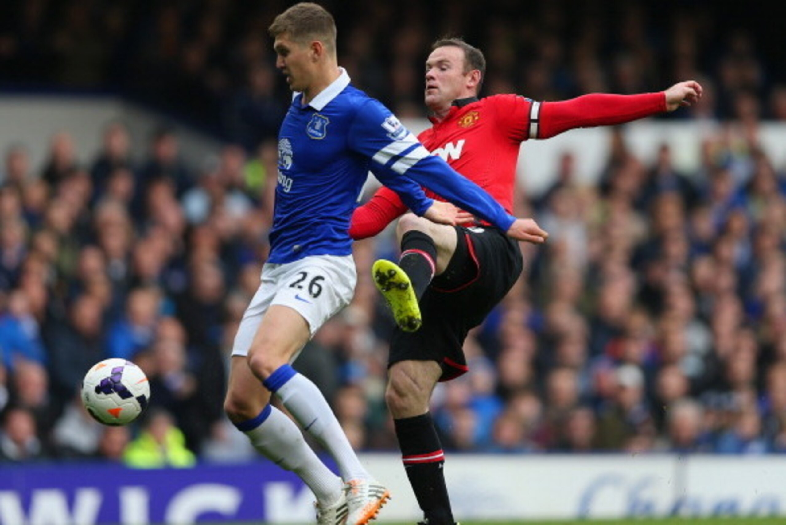 LIVERPOOL, ENGLAND - APRIL 20: John Stones of Everton and Wayne Rooney of Manchester United compete for the ball during the Barclays Premier League match between Everton and Manchester United at Goodison Park on April 20, 2014 in Liverpool, England. (Ph LIVERPOOL, ENGLAND - APRIL 20: John Stones of Everton and Wayne Rooney of Manchester United compete for the ball during the Barclays Premier League match between Everton and Manchester United at Goodison Park on April 20, 2014 in Liverpool, England. (Ph