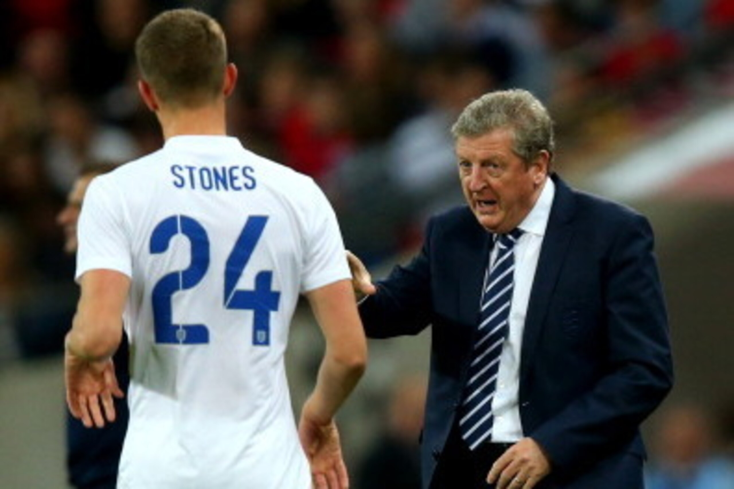 LONDON, ENGLAND - MAY 30:  Roy Hodgson, Manager of England speaks to John Stones of England during the international friendly match between England and Peru at Wembley Stadium on May 30, 2014 in London, England.  (Photo by Clive Rose/Getty Images)