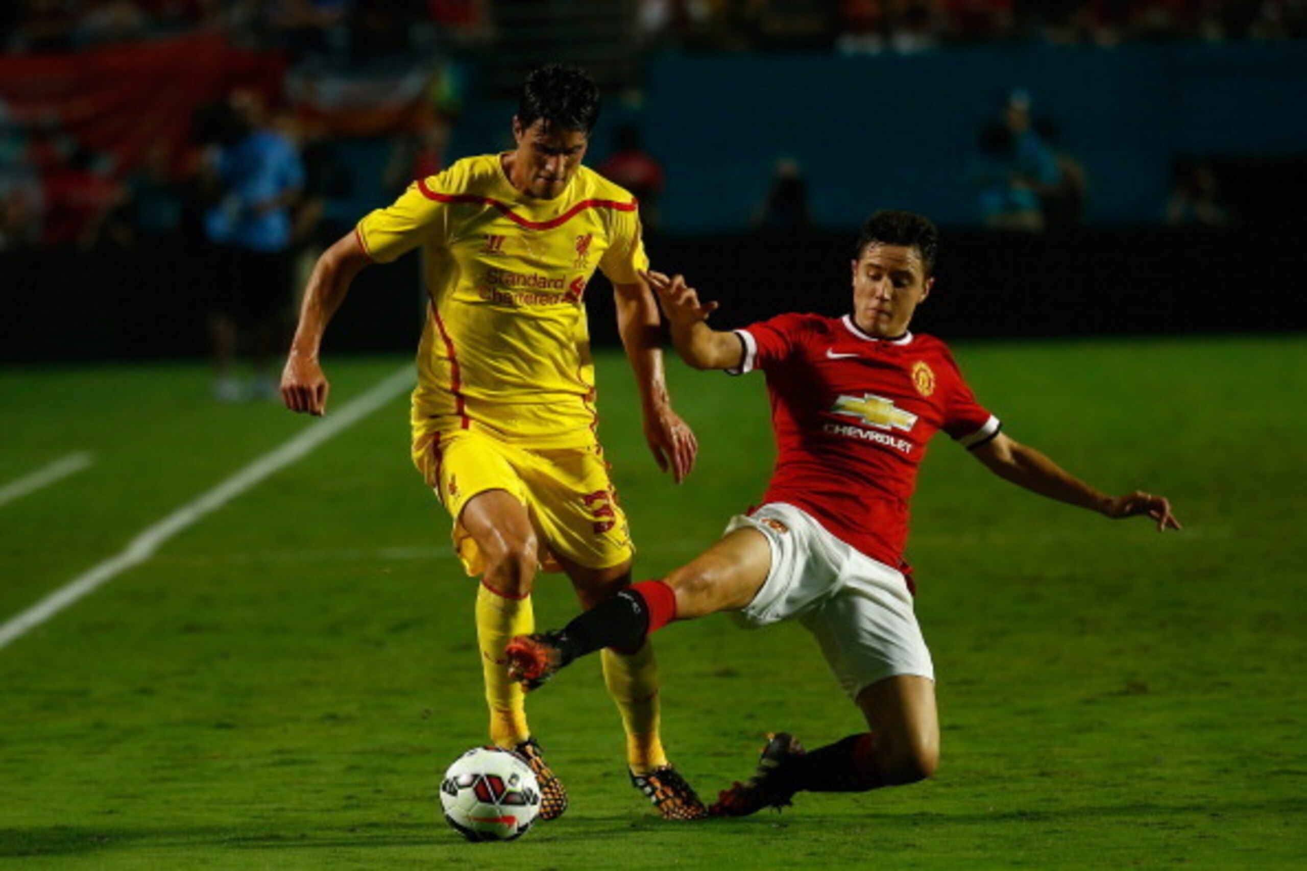 MIAMI GARDENS, FL - AUGUST 04: (L) Jose Enrique #3 of Liverpool is challenged by (R) Ander Herrera #21 of Manchester United  in the Guinness International Champions Cup 2014 Final at Sun Life Stadium on August 4, 2014 in Miami Gardens, Florida.  (Photo by
