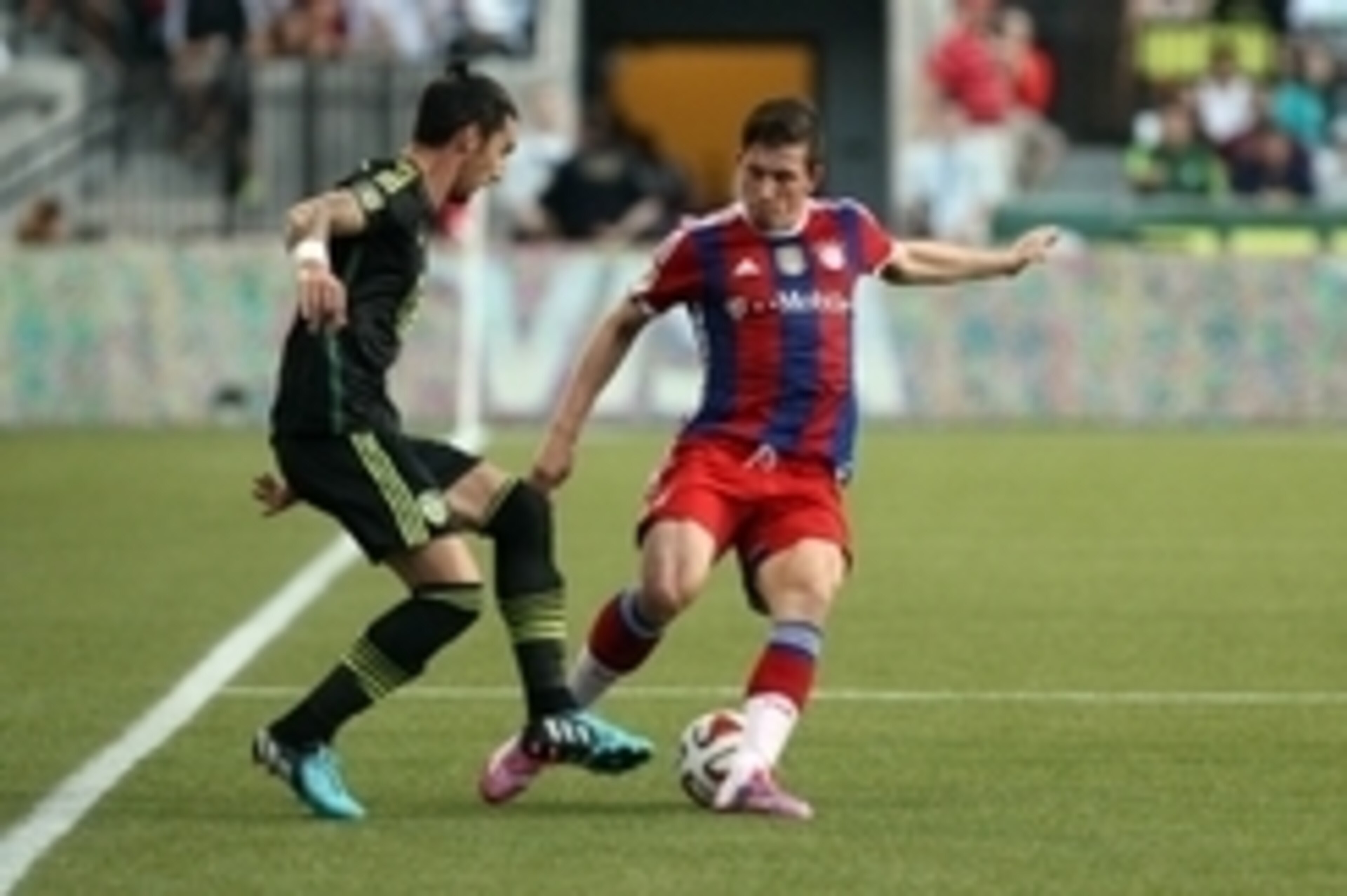 Aug 6, 2014; Portland, OR, USA; MLS All Stars defenseman Liam Ridgewell (24) of the Portland Timbers battles for the ball with Bayern Munich midfielder Pierre Hojbjerg (34) during the 2014 MLS All Star Game at Providence Park. Mandatory Credit: Jaime Vald