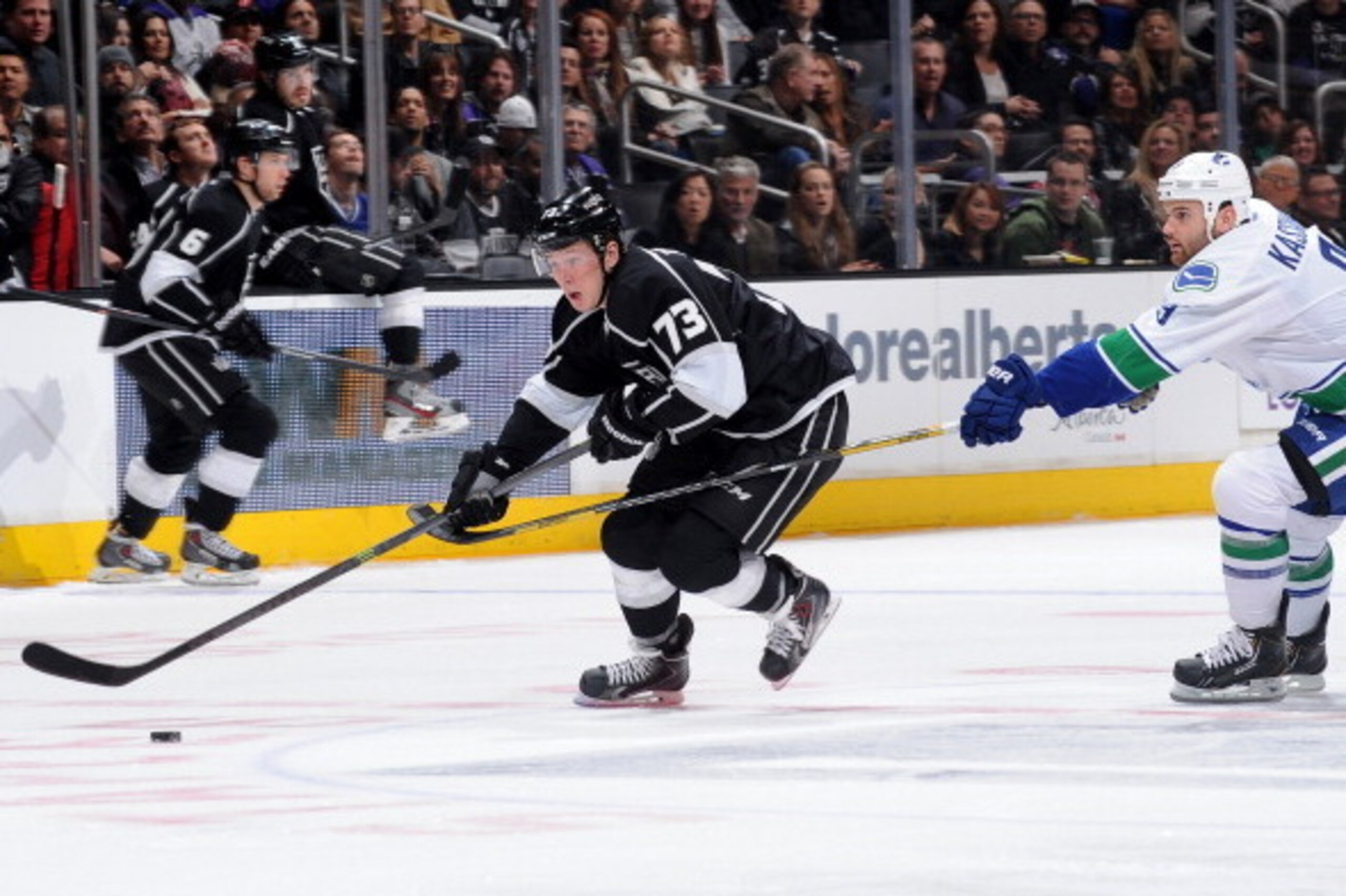 LOS ANGELES, CA - JANUARY 13:  Tyler Toffoli #73 of the Los Angeles Kings skates with the puck against Zack Kassian #9 of the Vancouver Canucks at Staples Center on January 13, 2014 in Los Angeles, California. (Photo by Noah Graham/NHLI via Getty Images)