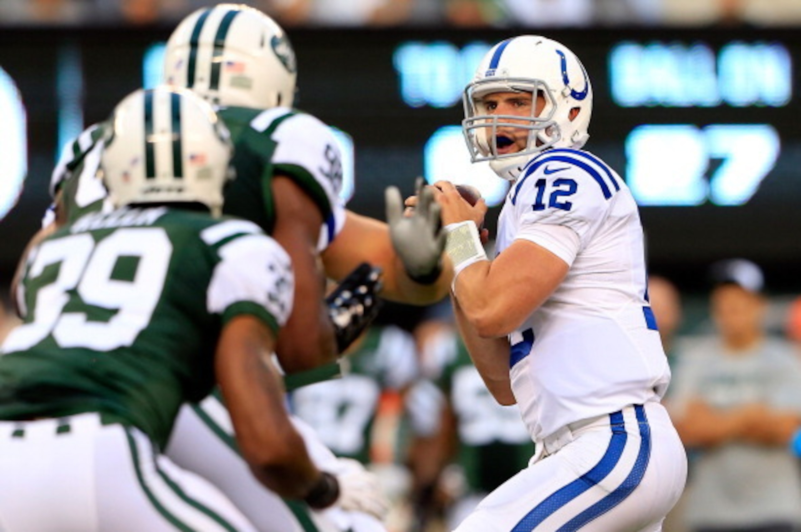 EAST RUTHERFORD, NJ - AUGUST 07: Quarterback Andrew Luck #12 of the Indianapolis Colts drops back to pass against the New York Jets during a preseason game at MetLife Stadium on August 7, 2014 in East Rutherford, New Jersey.  (Photo by Alex Trautwig/Getty