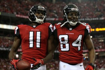 ATLANTA, GA - JANUARY 20:  Wide receiver Julio Jones #11 and wide receiver Roddy White #84 of the Atlanta Falcons celebrate after Jones catches a 20-yard touchdown catch in the second quarter against the San Francisco 49ers in the NFC Championship game at