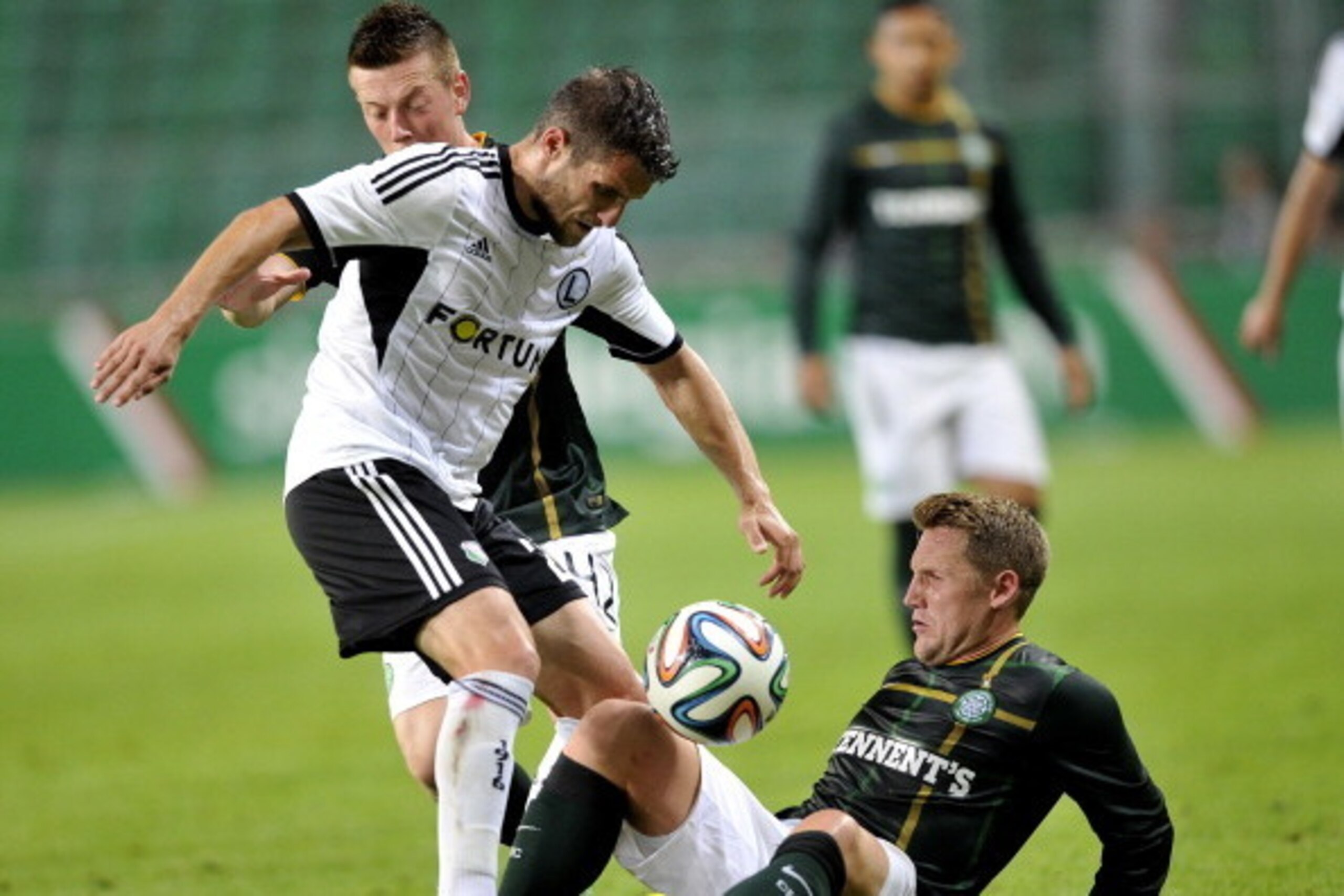 WARSAW, POLAND - JULY 30: Kris Commons and Callum McGregor of Celtic fight for the ball with Lukasz Broz of Legia during the third qualifying round UEFA Champions League match between Legia and Celtic at Pepsi Arena on July 30, 2014 in Warsaw, Poland. (Ph WARSAW, POLAND - JULY 30: Kris Commons and Callum McGregor of Celtic fight for the ball with Lukasz Broz of Legia during the third qualifying round UEFA Champions League match between Legia and Celtic at Pepsi Arena on July 30, 2014 in Warsaw, Poland. (Ph