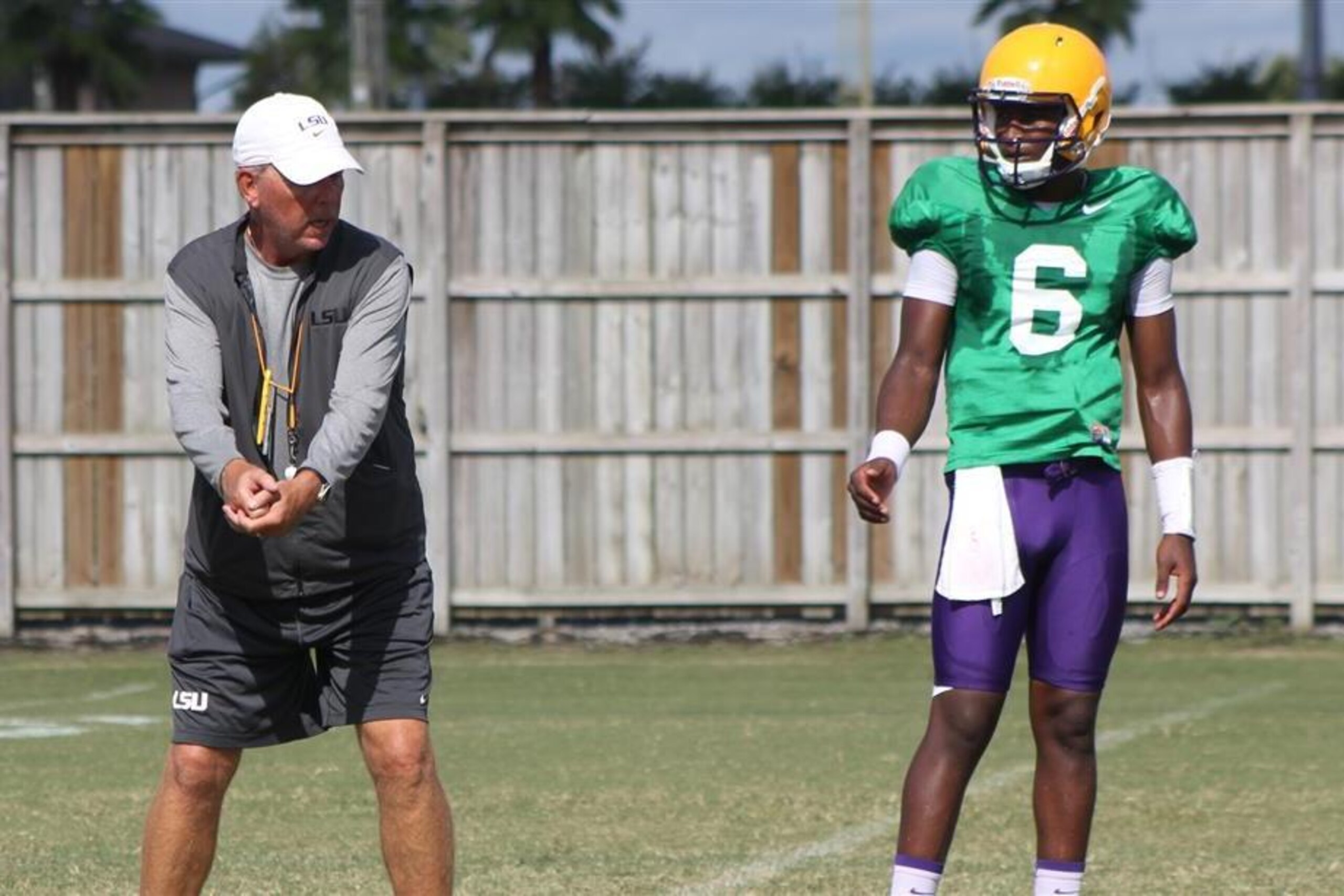 LSU offensive coordinator Cam Cameron (left) works with quarterback Brandon Harris (right)