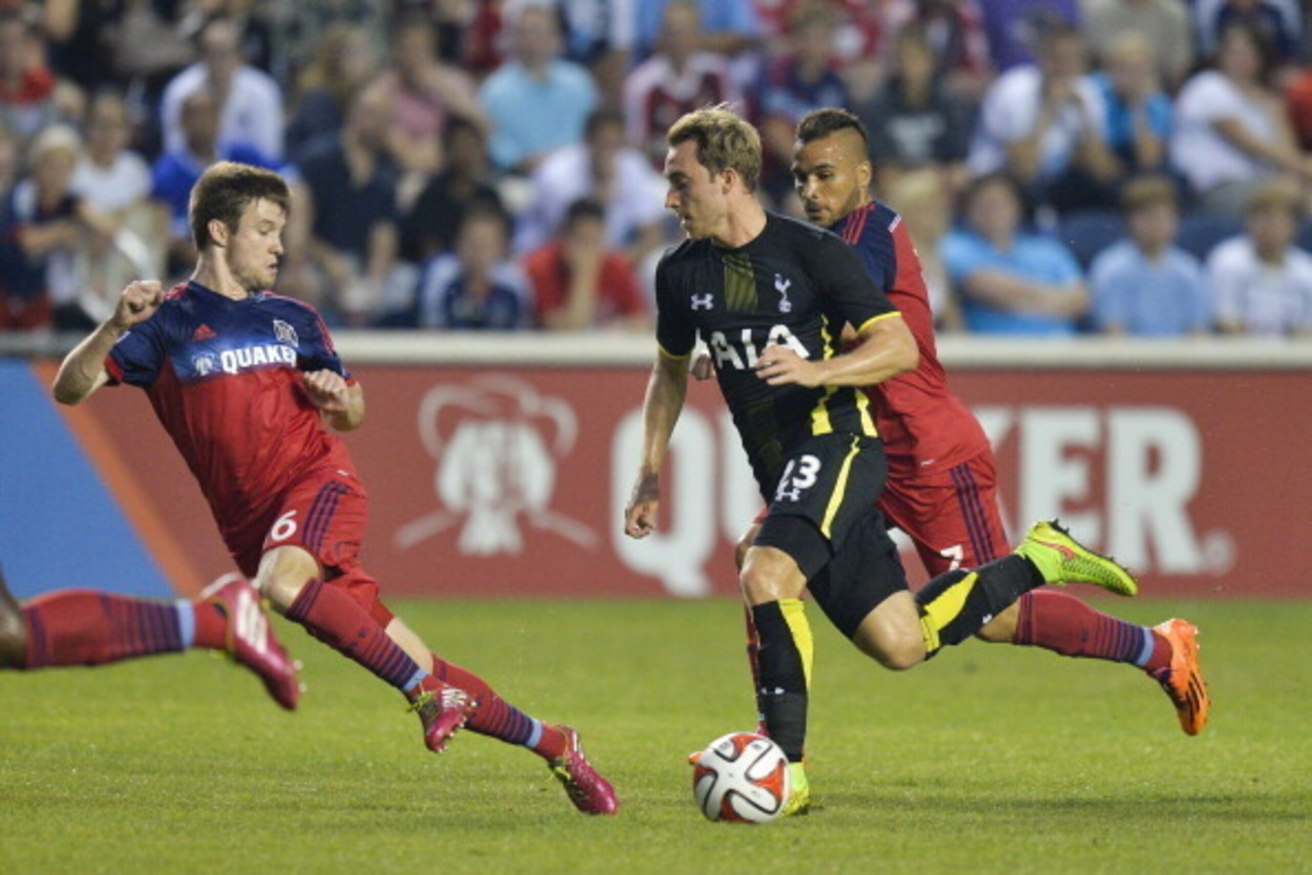 BRIDGEVIEW, IL - JULY 26:  Christian Eriksen #23 of Tottenham Hotspur (C) moves the ball up the field as Greg Cochrane #16 and Alex #7 of Chicago Fire defend during the second half at Toyota Park on July 26, 2014 in Bridgeview, Illinois. Tottenham Hotspur