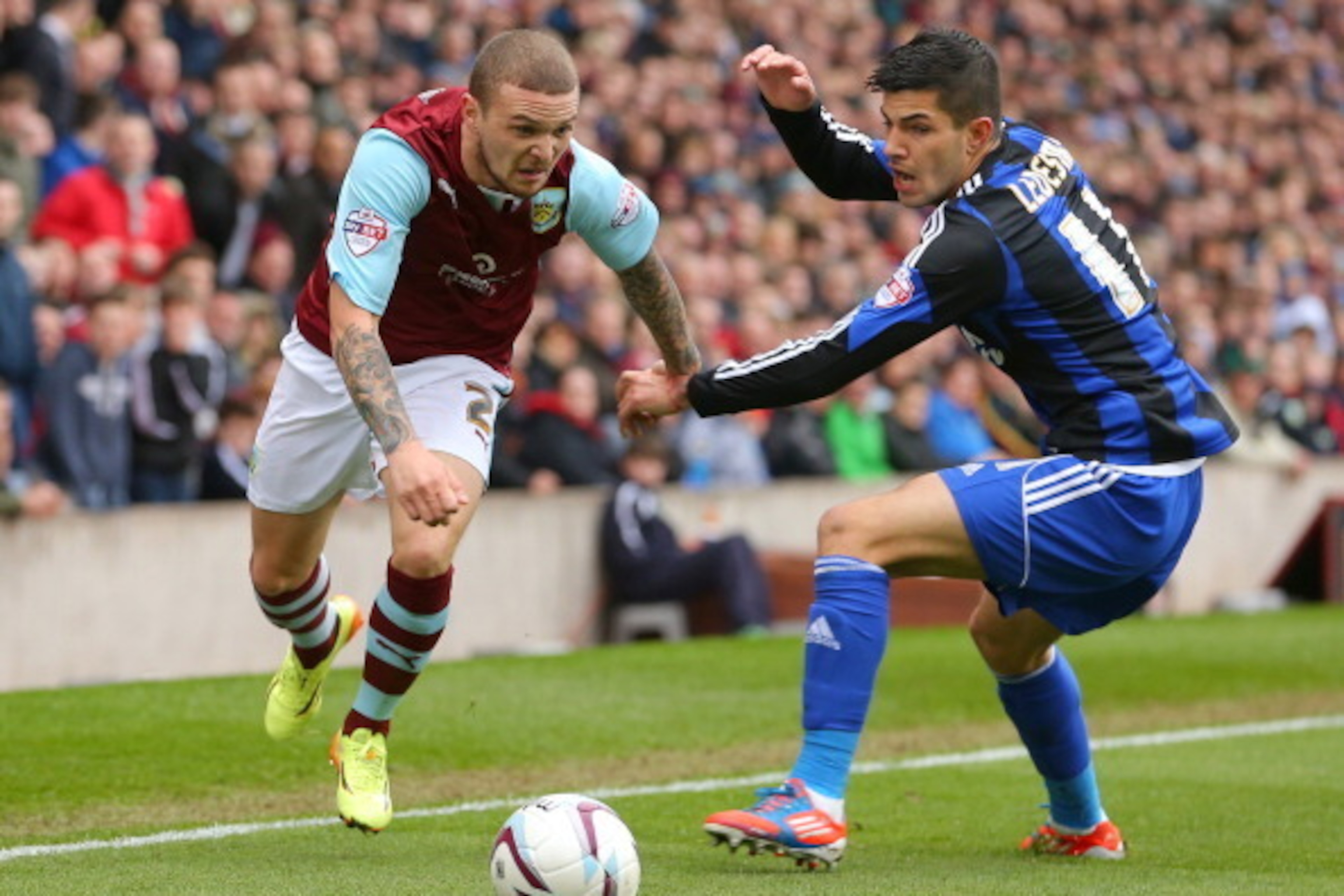 BURNLEY, ENGLAND - APRIL 12: Burnley's Kieran Trippier (L) gets past Middlesbrough's Emanuel Ledesma during the Sky Bet Championship match between Burnley and Middlesbrough at Turf Moor on April 12, 2014 in Burnley, England.  (Photo by Dave Thompson/Getty