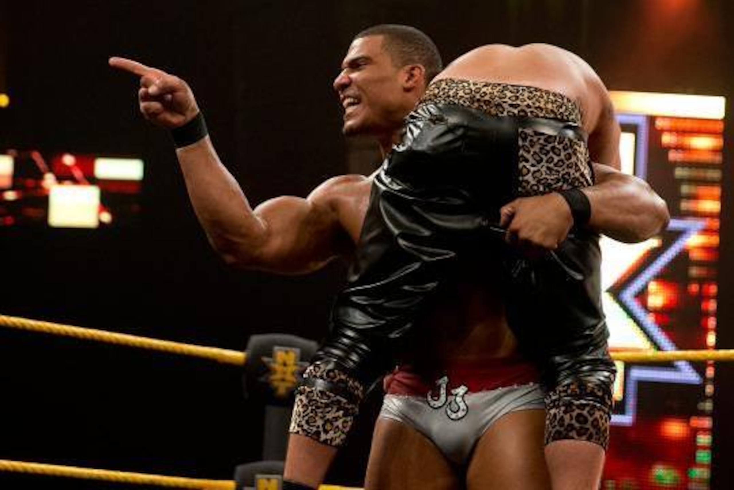 Jason Jordan lifts Enzo Amore while taunting Colin Cassady.
