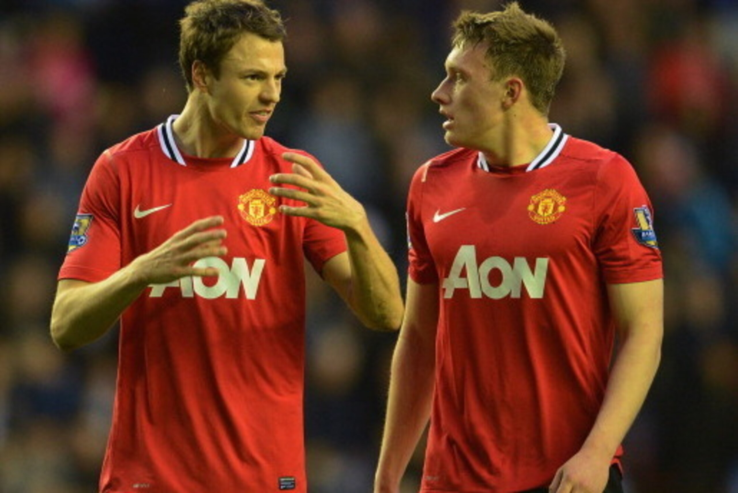 WIGAN, ENGLAND - APRIL 11: Jonny Evans of Manchester United speaks to team mate Phil Jones during the Barclays Premier League match between Wigan Athletic and Manchester United at the DW Stadium on April 11, 2012 in Wigan, England. (Photo by Michael Rega WIGAN, ENGLAND - APRIL 11: Jonny Evans of Manchester United speaks to team mate Phil Jones during the Barclays Premier League match between Wigan Athletic and Manchester United at the DW Stadium on April 11, 2012 in Wigan, England. (Photo by Michael Rega