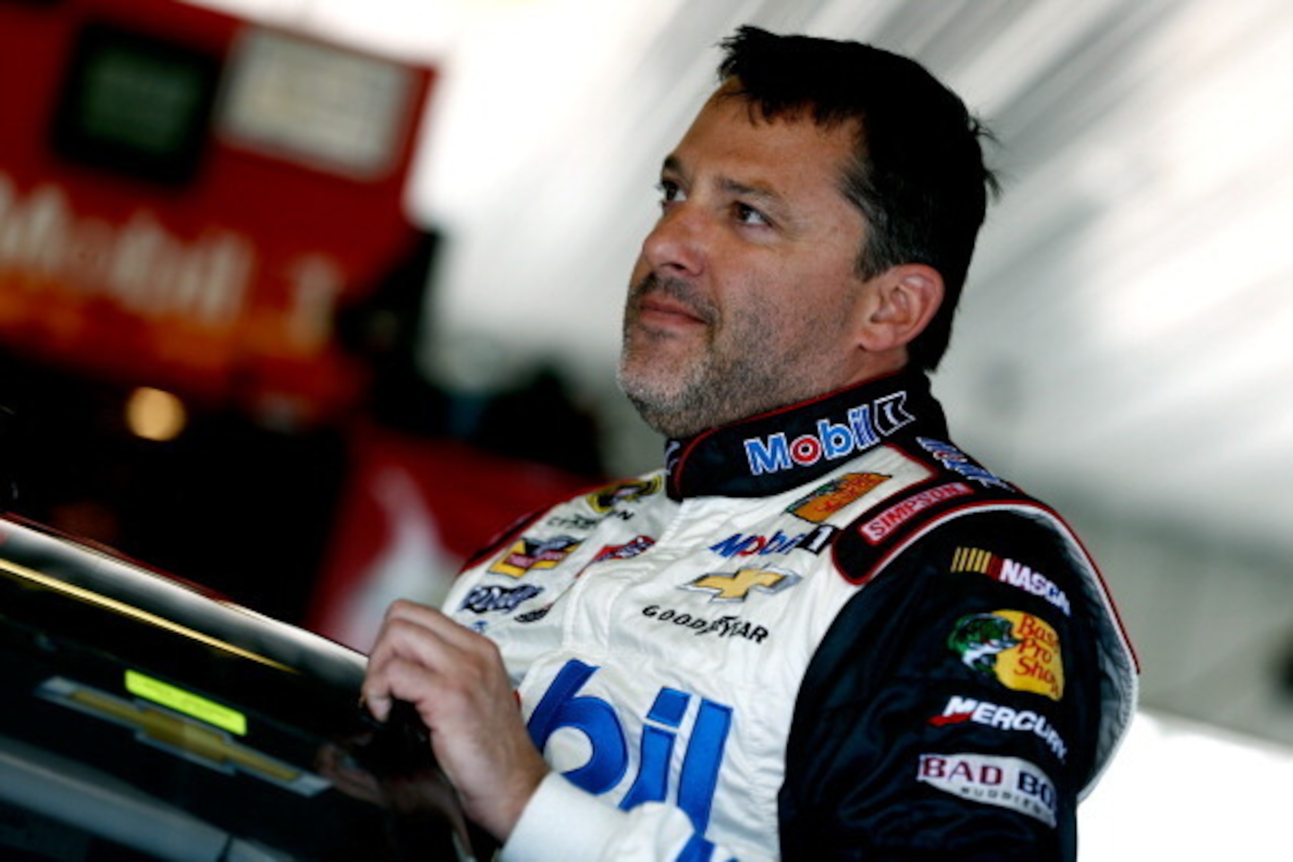 LONG POND, PA - JUNE 07:  Tony Stewart, driver of the #14 Mobil 1/Bass Pro Shops Chevrolet, looks on in the garage area during practice for the NASCAR Sprint Cup Series Pocono 400 at Pocono Raceway on June 7, 2014 in Long Pond, Pennsylvania.  (Photo by Je