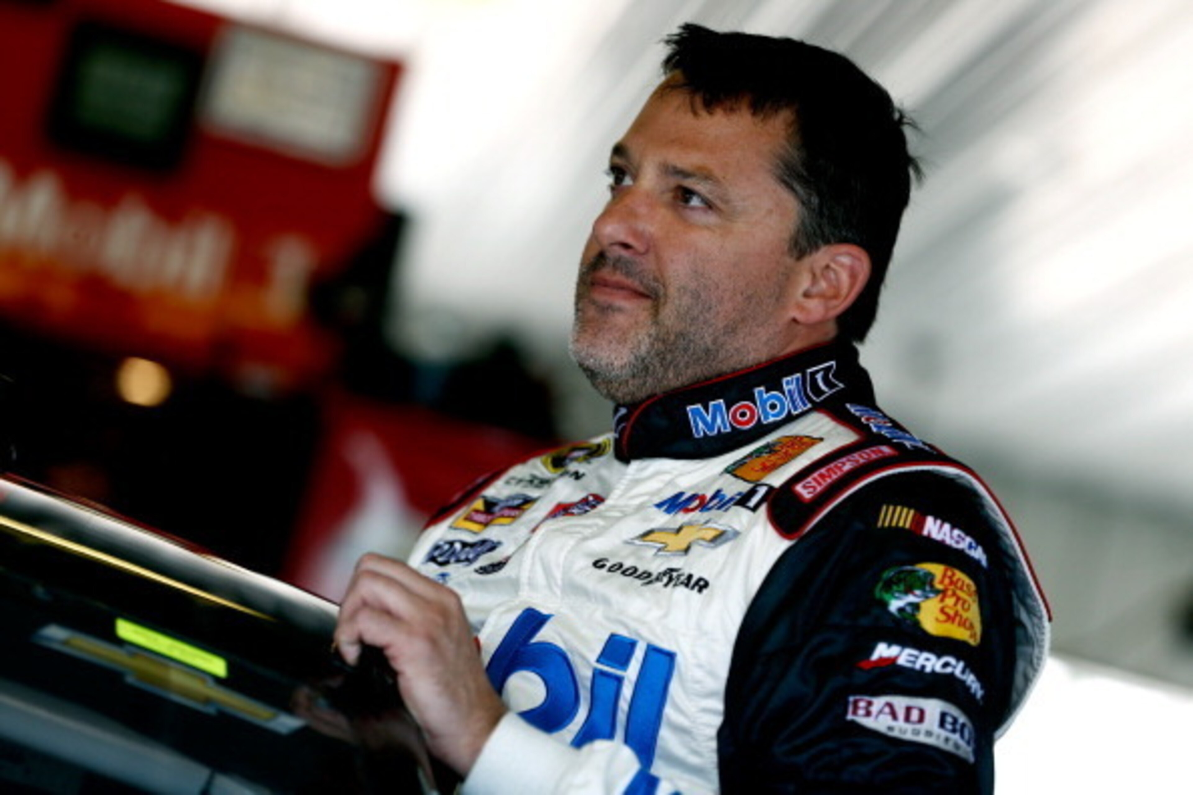 LONG POND, PA - JUNE 07:  Tony Stewart, driver of the #14 Mobil 1/Bass Pro Shops Chevrolet, looks on in the garage area during practice for the NASCAR Sprint Cup Series Pocono 400 at Pocono Raceway on June 7, 2014 in Long Pond, Pennsylvania.  (Photo by Je