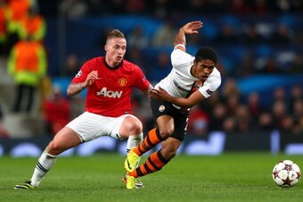 MANCHESTER, ENGLAND - DECEMBER 10:  Alexander Buttner of Manchester United competes with Douglas Costa of Shakhtar Donetsk during the UEFA Champions League Group A match between Manchester United and Shakhtar Donetsk at Old Trafford on December 10, 2013 i
