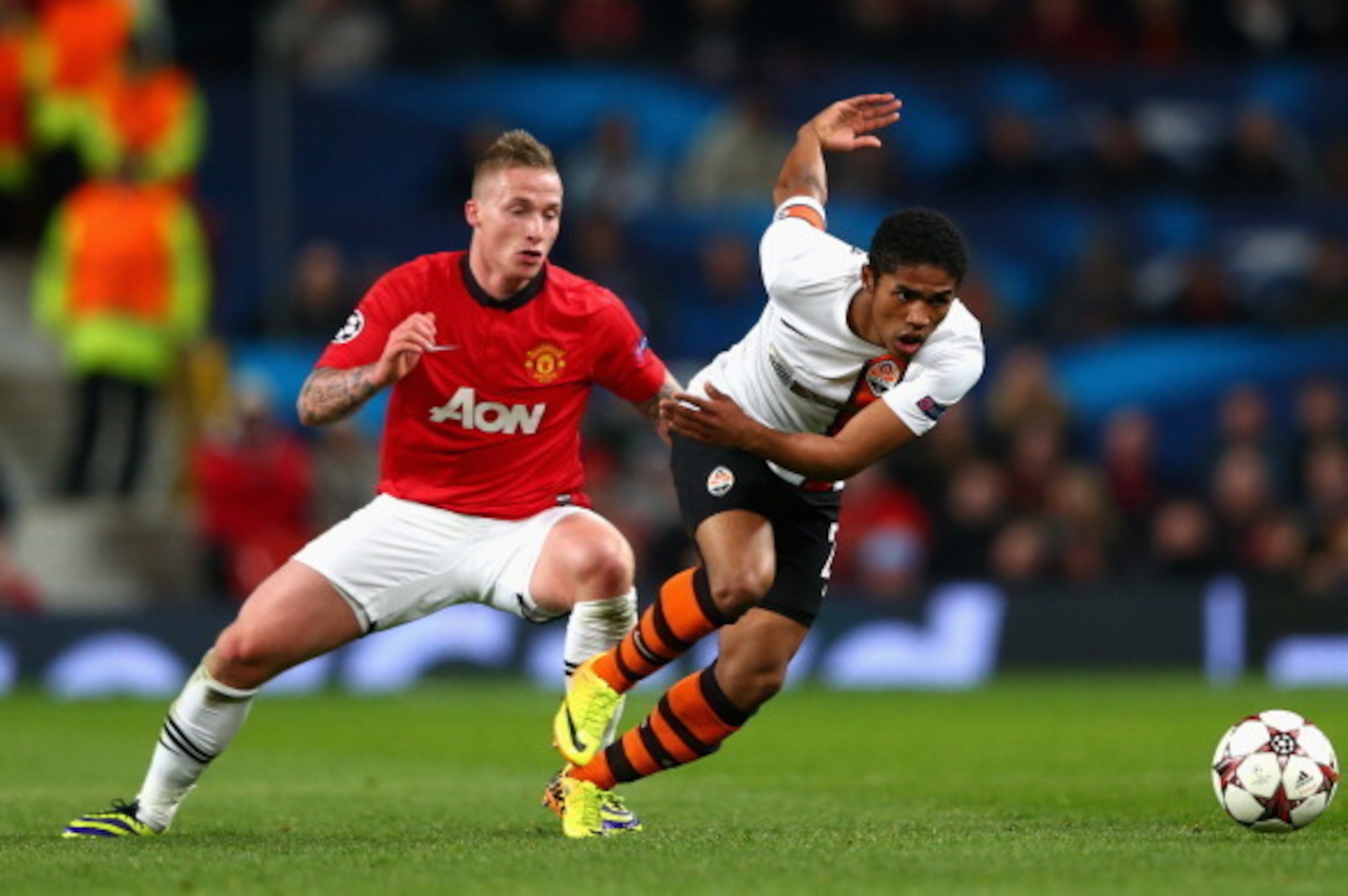 MANCHESTER, ENGLAND - DECEMBER 10:  Alexander Buttner of Manchester United competes with Douglas Costa of Shakhtar Donetsk during the UEFA Champions League Group A match between Manchester United and Shakhtar Donetsk at Old Trafford on December 10, 2013 i