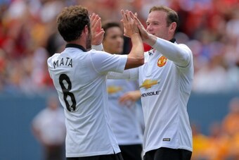 DENVER, CO - JULY 26: Wayne Rooney #10 of Manchester United celebrates his second goal with Juan Mata #8 during the first half of an International Champions Cup match against AS Roma at Sports Authority Field at Mile High on July 26, 2014 in Denver, Color