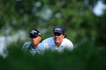 LOUISVILLE, KY - AUGUST 09:  Phil Mickelson (R) of the United States and caddie Jim 'Bones' Mackay look on from the 18th tee during the third round of the 96th PGA Championship at Valhalla Golf Club on August 9, 2014 in Louisville, Kentucky.  (Photo by Da
