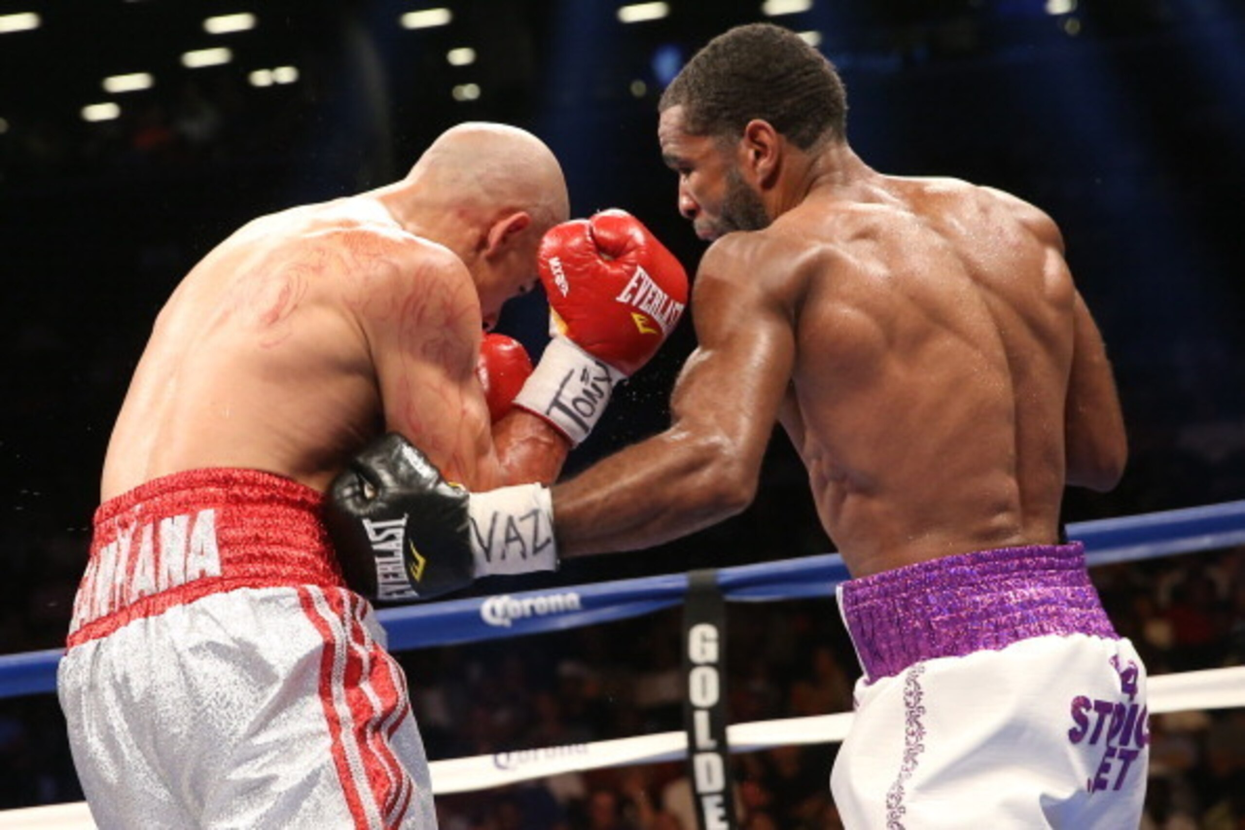 BROOKLYN, NY - AUGUST 9: Lamont Peterson (White w/Purple trunks) lands a body shot to Edgar Santana (Silver w/Red trunks) during their IBF junior welterweight championship fight at the Barclays Center on August 9, 2014 in Brooklyn, New York. (Photo by Ed BROOKLYN, NY - AUGUST 9: Lamont Peterson (White w/Purple trunks) lands a body shot to Edgar Santana (Silver w/Red trunks) during their IBF junior welterweight championship fight at the Barclays Center on August 9, 2014 in Brooklyn, New York. (Photo by Ed