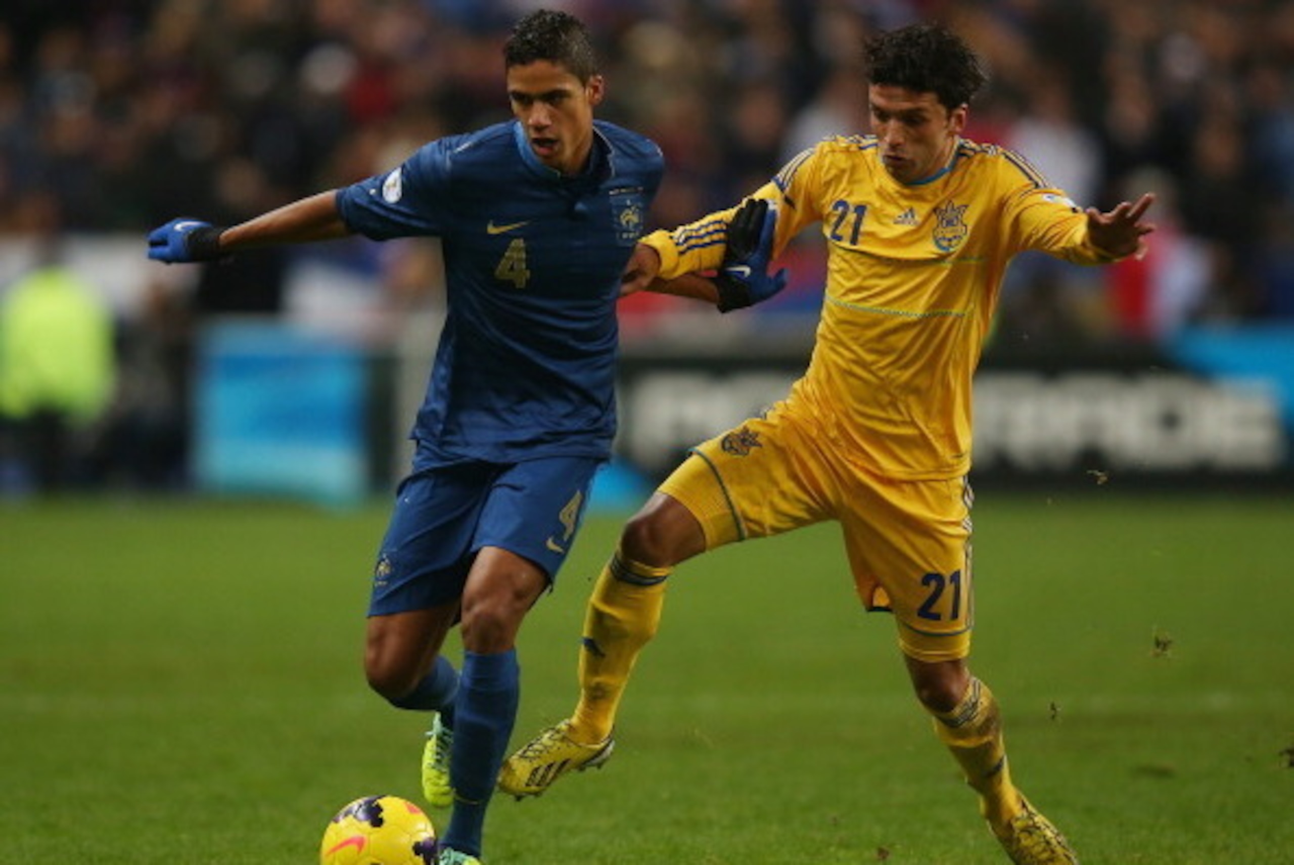 PARIS, FRANCE - NOVEMBER 19:  Raphael Varane of France battles with Edmar De Lacerda of the Ukraine during the FIFA 2014 World Cup Qualifier Play-off second leg match between France and Ukraine at the Stade de France on November 19, 2013 in Paris, France.