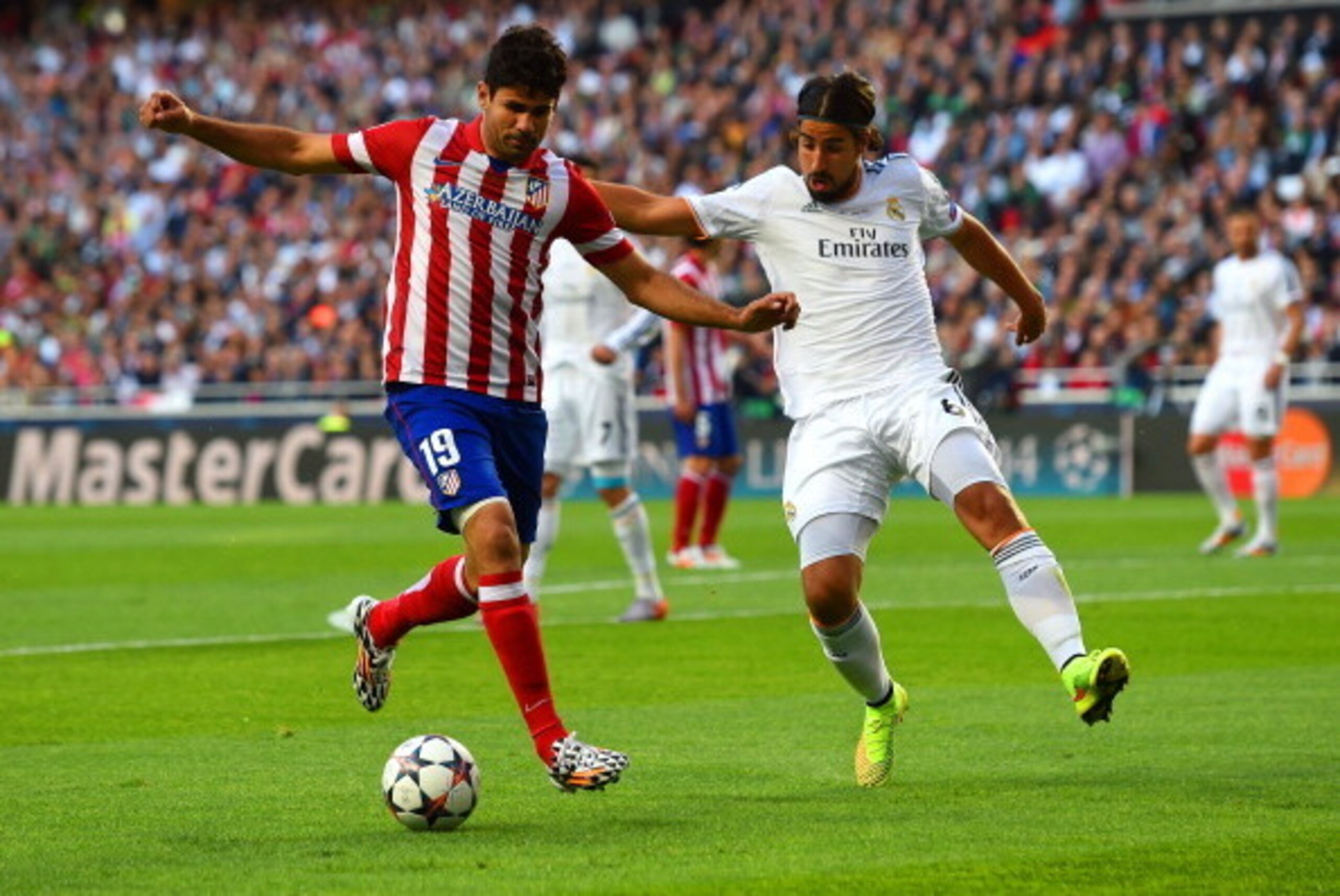 LISBON, PORTUGAL - MAY 24:  Diego Costa of Club Atletico de Madrid is marshalled by Sami Khedira of Real Madrid during the UEFA Champions League Final between Real Madrid and Atletico de Madrid at Estadio da Luz on May 24, 2014 in Lisbon, Portugal.  (Phot