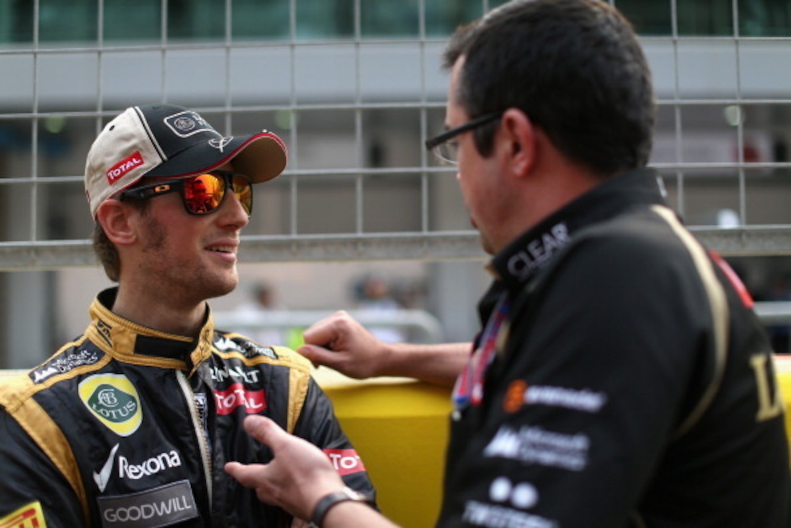 YEONGAM-GUN, SOUTH KOREA - OCTOBER 14:  Romain Grosjean of France and Lotus talks with his Team Principal Eric Boullier as he prepares to drive during the Korean Formula One Grand Prix at the Korea International Circuit on October 14, 2012 in Yeongam-gun,