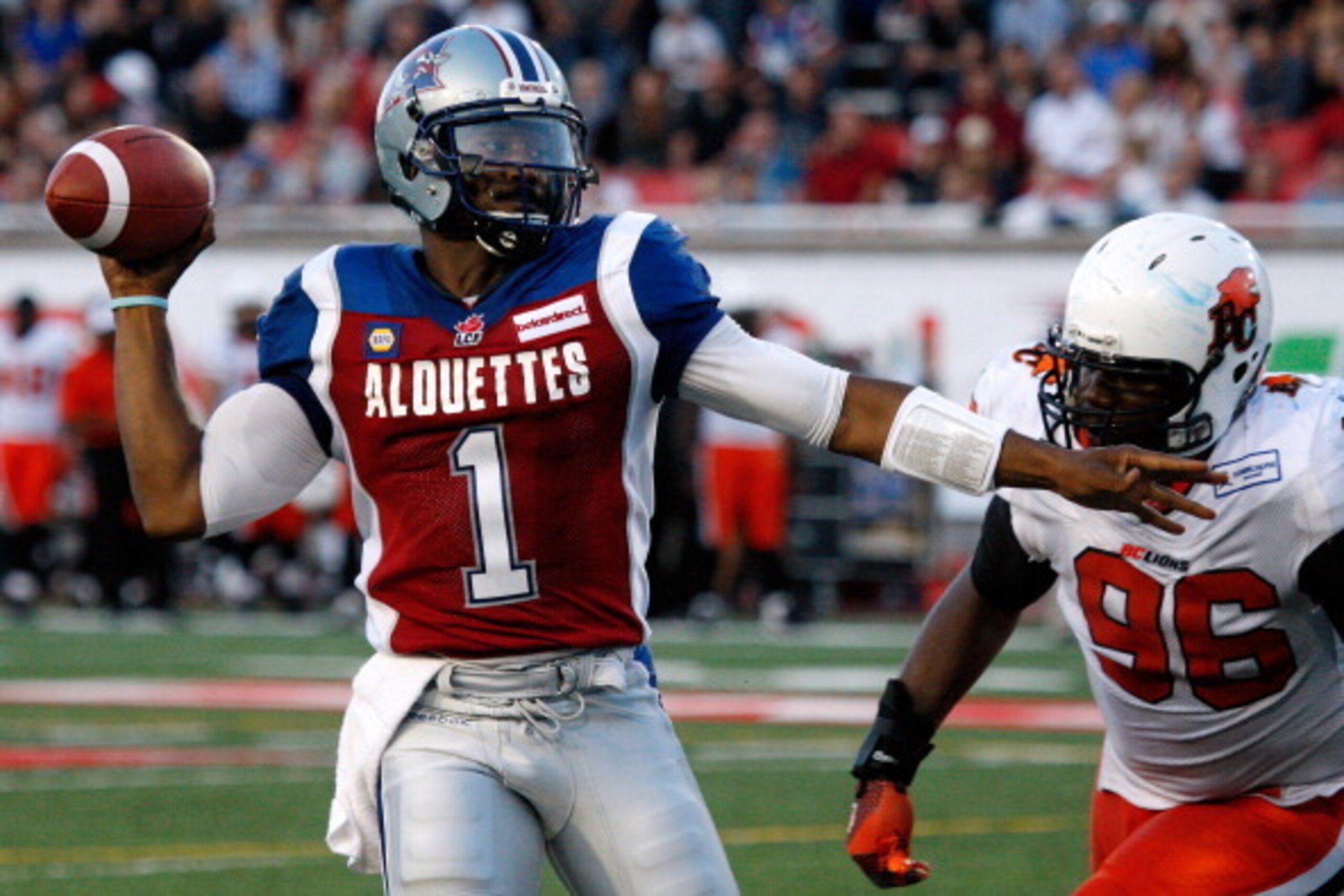 MONTREAL, QC - JULY 4: Troy Smith  #1 of the Montreal Alouettes passes the ball in front of Khalif Mitchell #96 of the BC Lions during the CFL game at Percival Molson Stadium on July 4, 2014 in Montreal, Quebec, Canada.  (Photo by Richard Wolowicz/Getty I