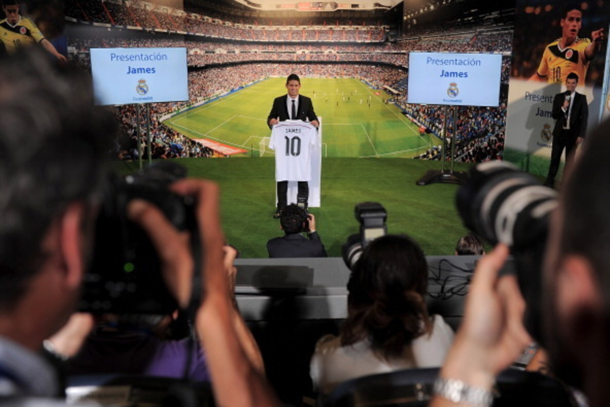 MADRID, SPAIN - JULY 22:  James Rodriguez holds his new Real shirt during his unveiling as a new Real Madrid player at the Santaigo Bernabeu stadium on July 22, 2014 in Madrid, Spain. Real agreed to buy Rodriguez from AS Monaco for the next six seasons fo
