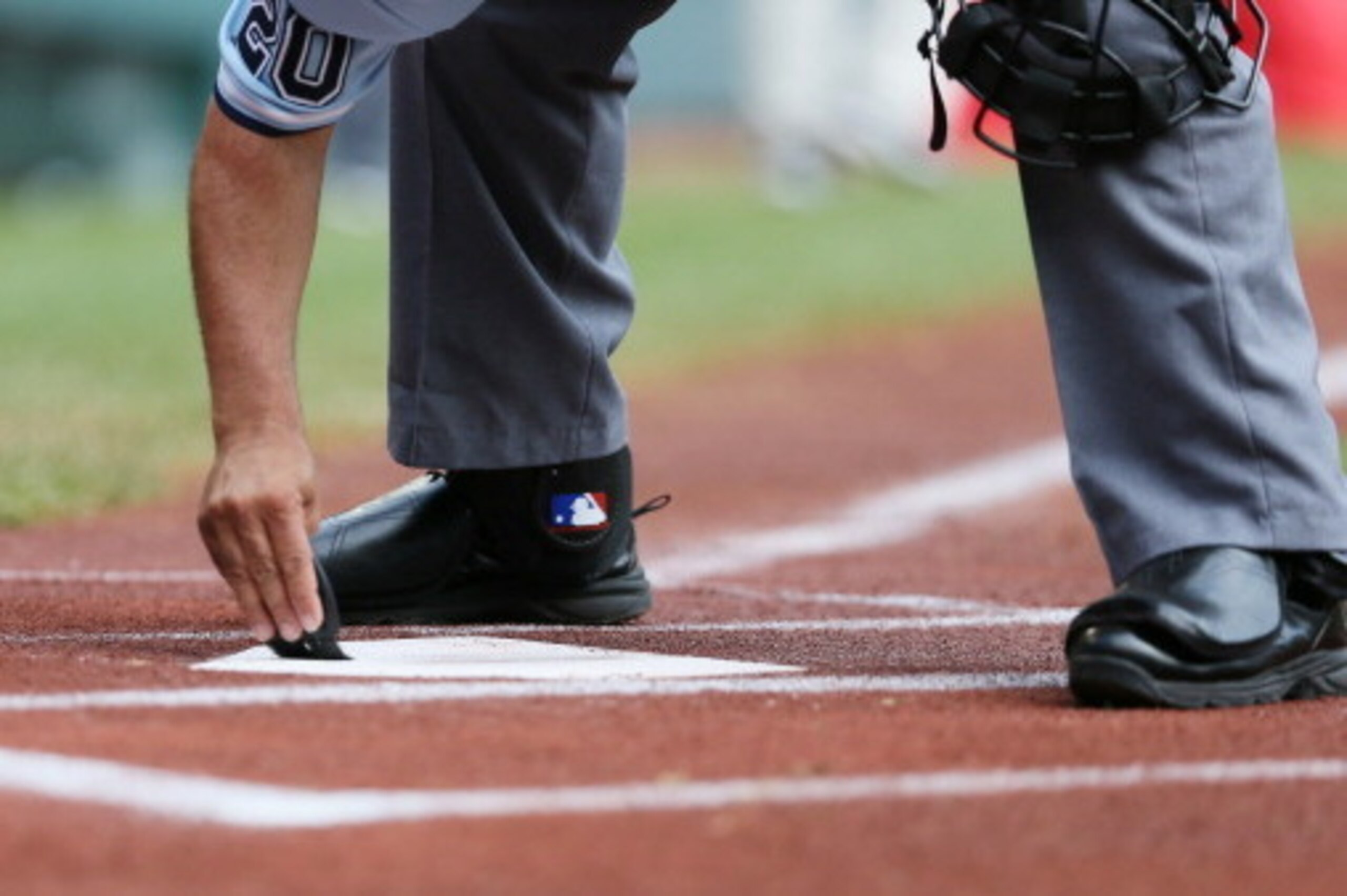 WILLIAMSPORT, PA - AUGUST 25:  The home plate umpire cleans the plate between innings of the West team from Chula Vista, Ca and the Tokyo, Japan team during the fourth inning of the Little League World Series Championship game on August 25, 2013 in Willia