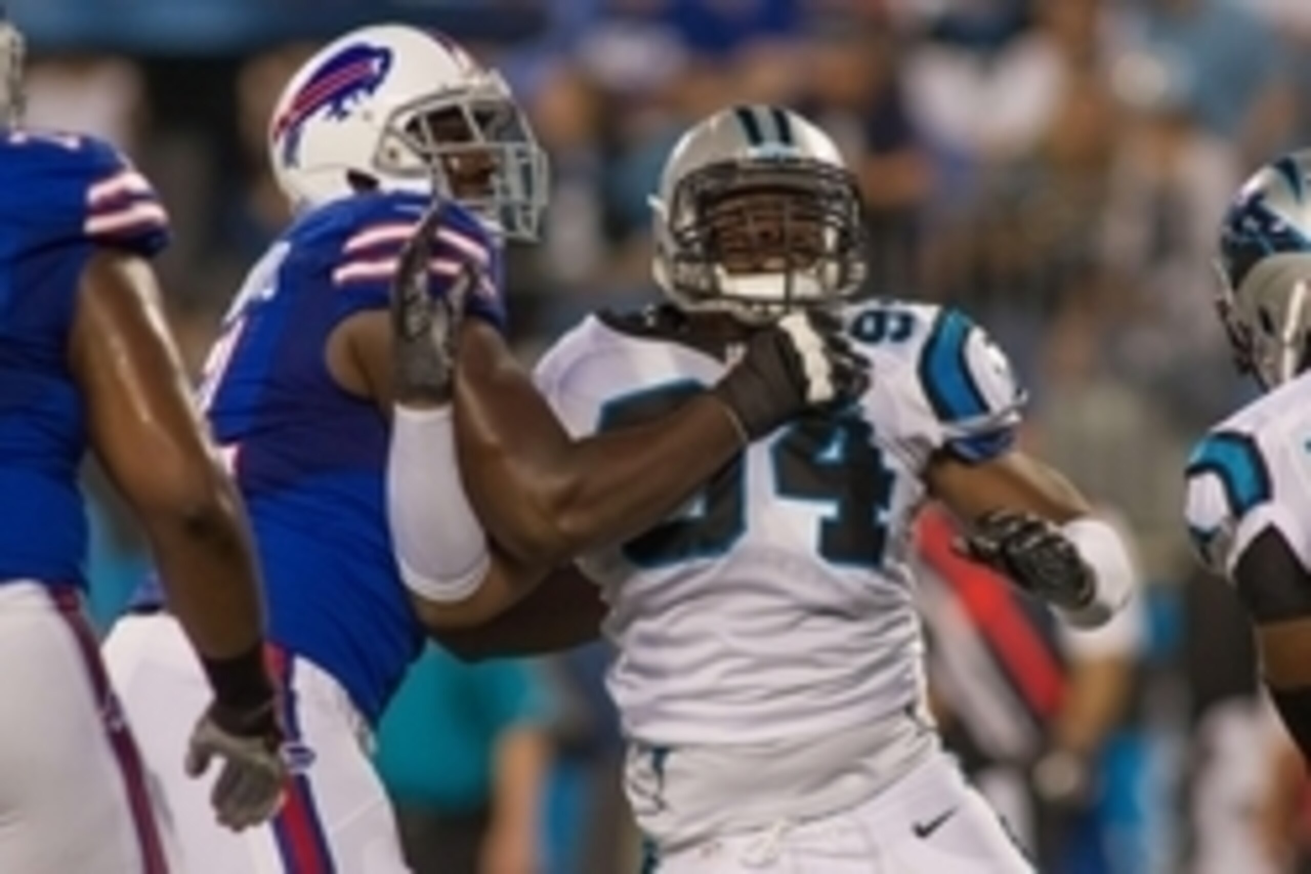 Aug 8, 2014; Charlotte, NC, USA; Carolina Panthers defensive end Kony Ealy (94) gets blocked by Buffalo Bills offensive tackle Cyrus Kouandjio (71) during the third quarter at Bank of America Stadium. Buffalo defeated Carolina 20-18. Mandatory Credit: Jer