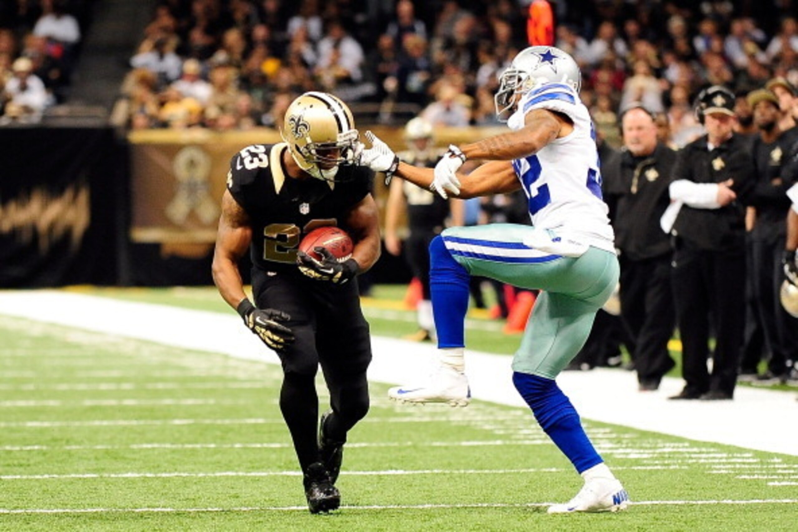 NEW ORLEANS, LA - NOVEMBER 10:  Orlando Scandrick #32 of the Dallas Cowboys tries to tackle Pierre Thomas #23 of the New Orleans Saints during a game at the Mercedes-Benz Superdome on November 10, 2013 in New Orleans, Louisiana.  (Photo by Stacy Revere/Ge