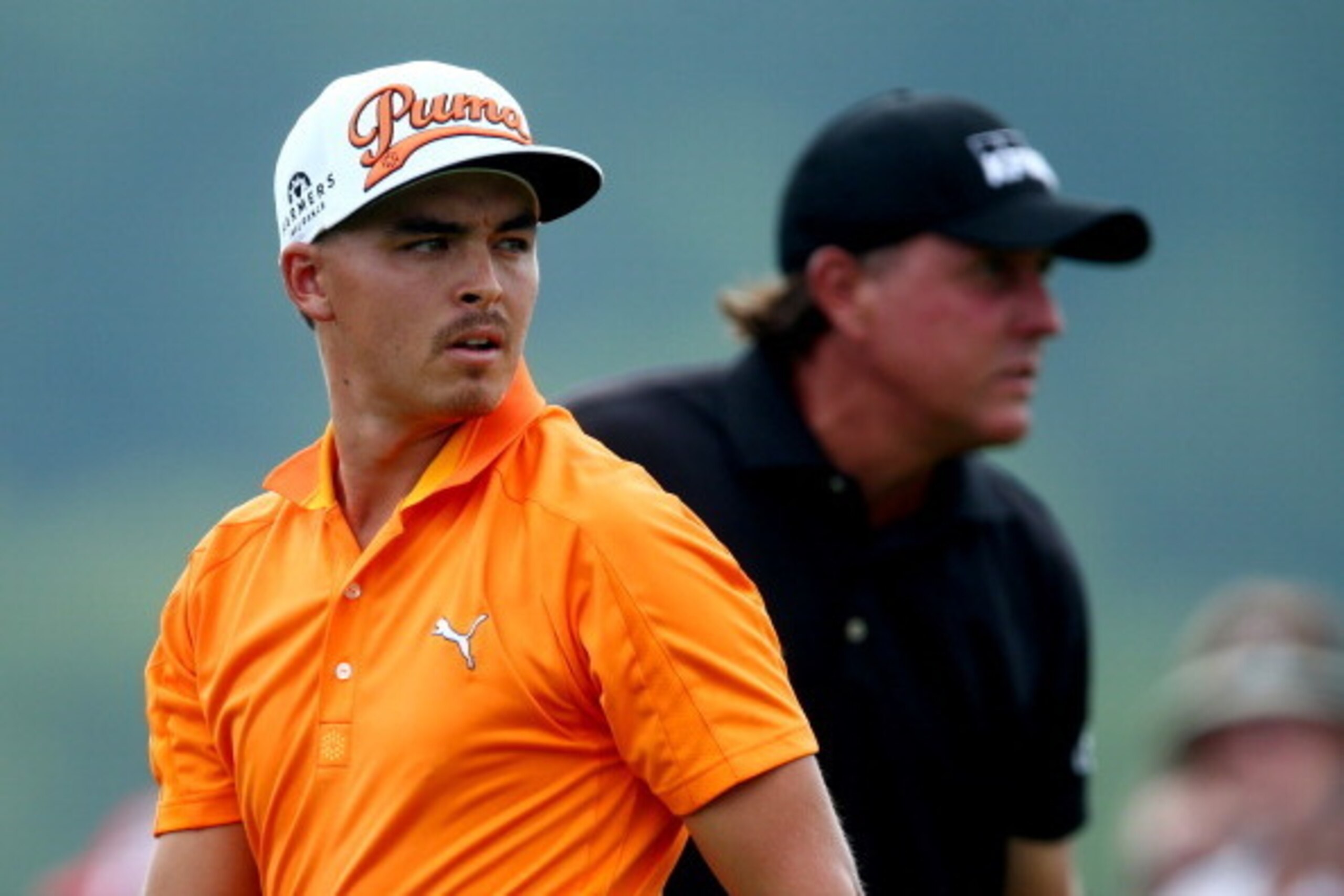 LOUISVILLE, KY - AUGUST 10: (L-R) Rickie Fowler of the United States and Phil Mickelson of the United States look on from the first hole tee during the final round of the 96th PGA Championship at Valhalla Golf Club on August 10, 2014 in Louisville, Kentuc