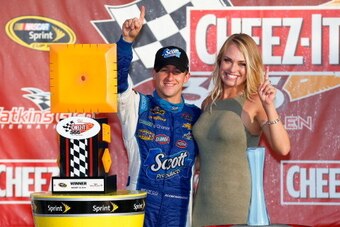 WATKINS GLEN, NY - AUGUST 10:  AJ Allmendinger, driver of the #47 Scott Products Chevrolet, poses with girlfriend Tara Lea in Victory Lane after winning the NASCAR Sprint Cup Series Cheez-It 355 at Watkins Glen International on August 10, 2014 in Watkins 